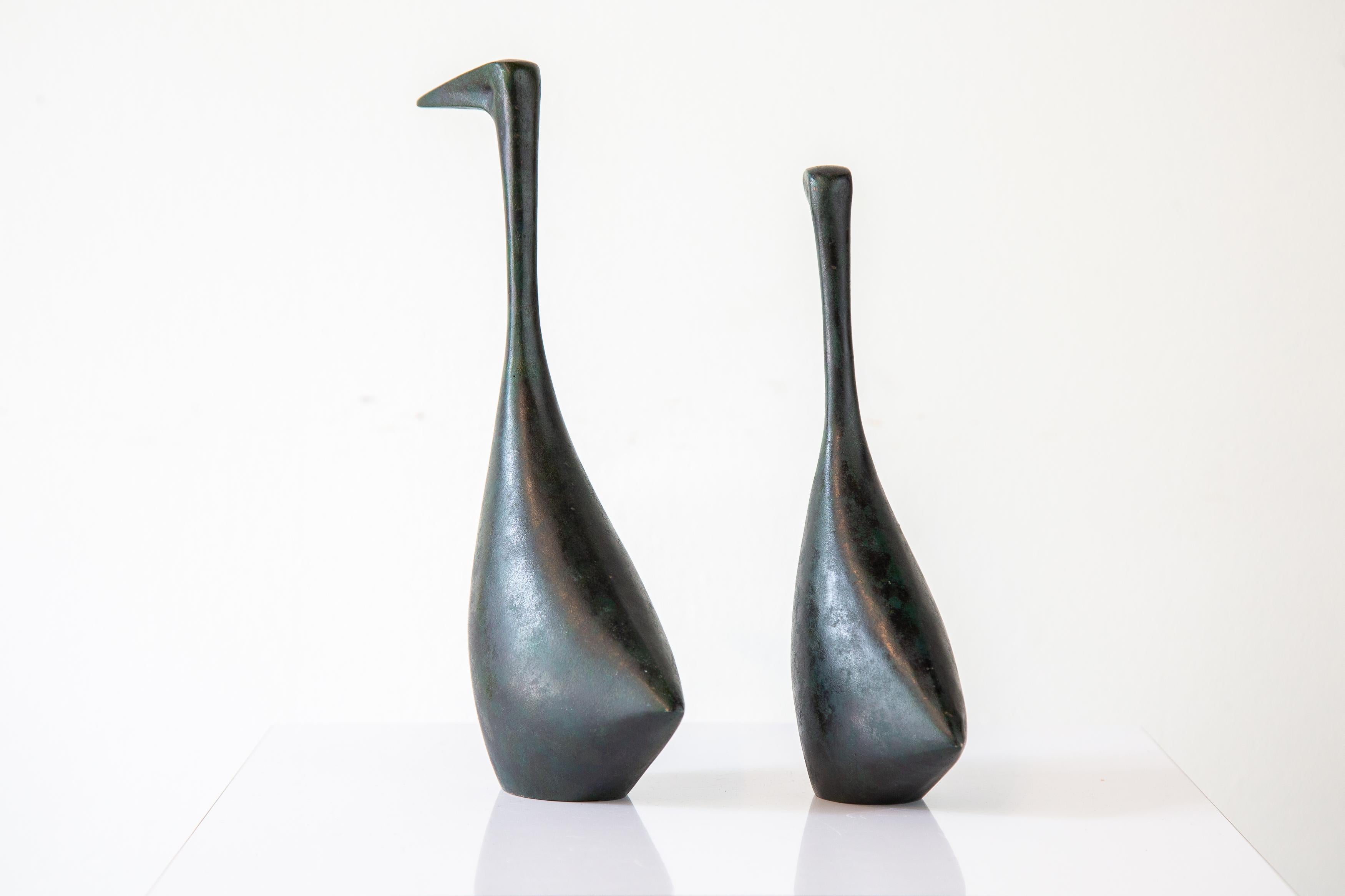 Vintage table top bird sculptures in the style of Isamu Noguchi. Cast iron, hollowed body, with an elegant form with an applied Verdi gris patina.

Dimensions: 
(Large) 10.5”H x 2.75”W x 7”D
(Small) 9”H x 2.25”W x 5”D

Condition: Very nice vintage