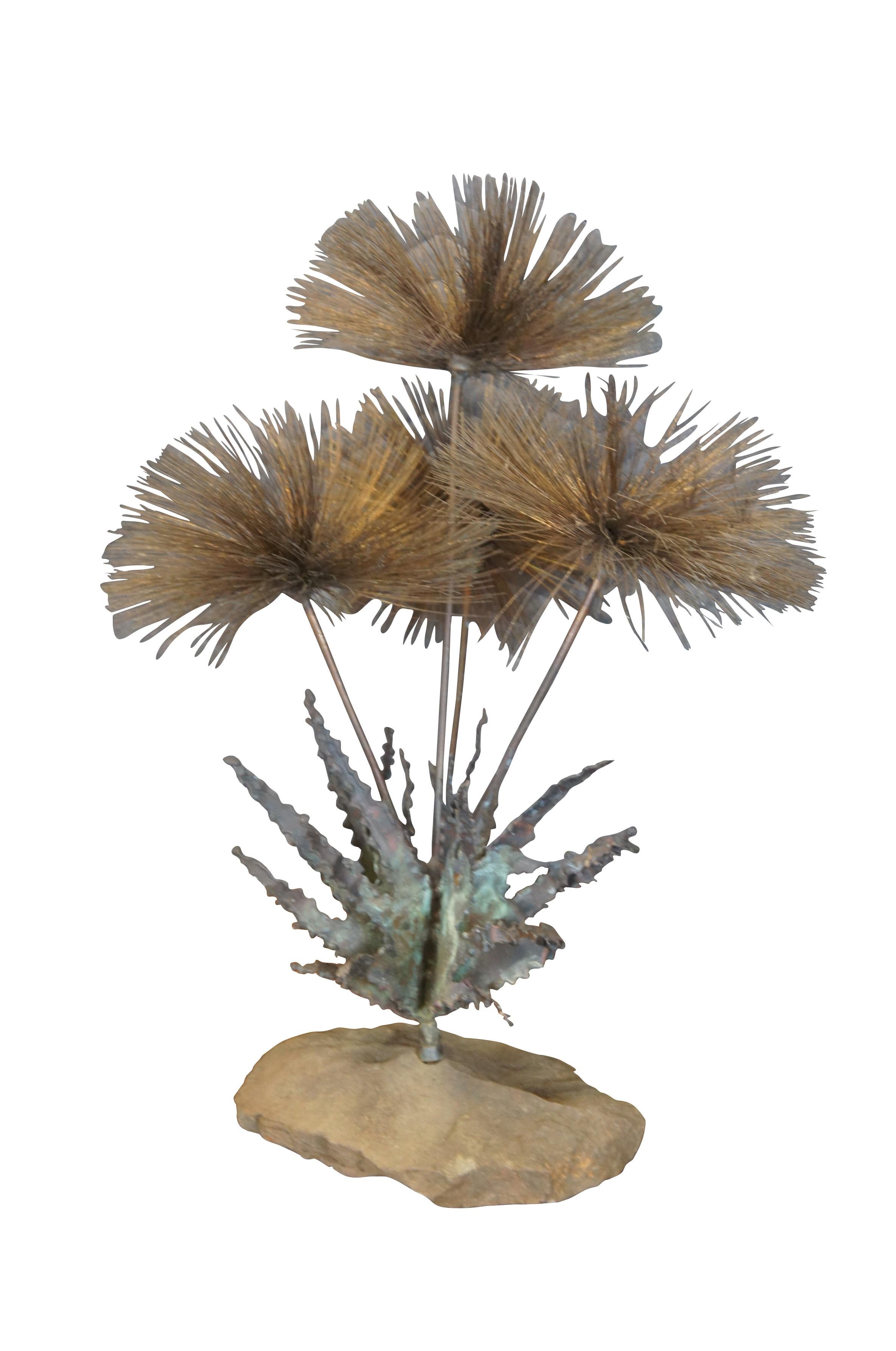 Circa 1960s brutalist sculpture titled Desert Flowers by artist John Steck. Features four dandelion shaped blossoms perched above spiky metal leaves, mounted on a natural stone base.


Dimensions:
9