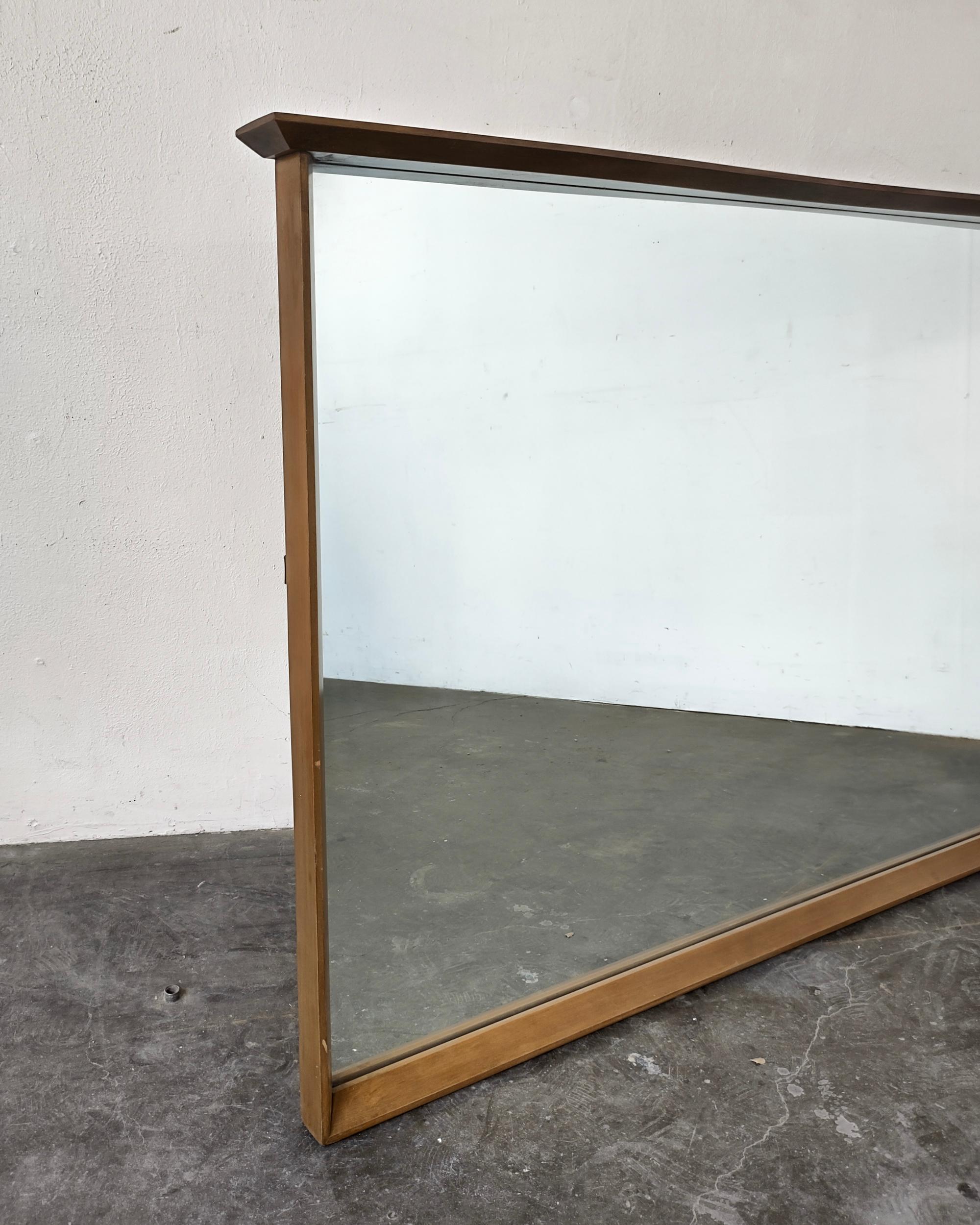 Large Mid-Century Modern horizontal mirror circa 1960s. Beveled wood frame with top edge detail. Hanging wire attached on back. Overall excellent vintage condition.

51.5