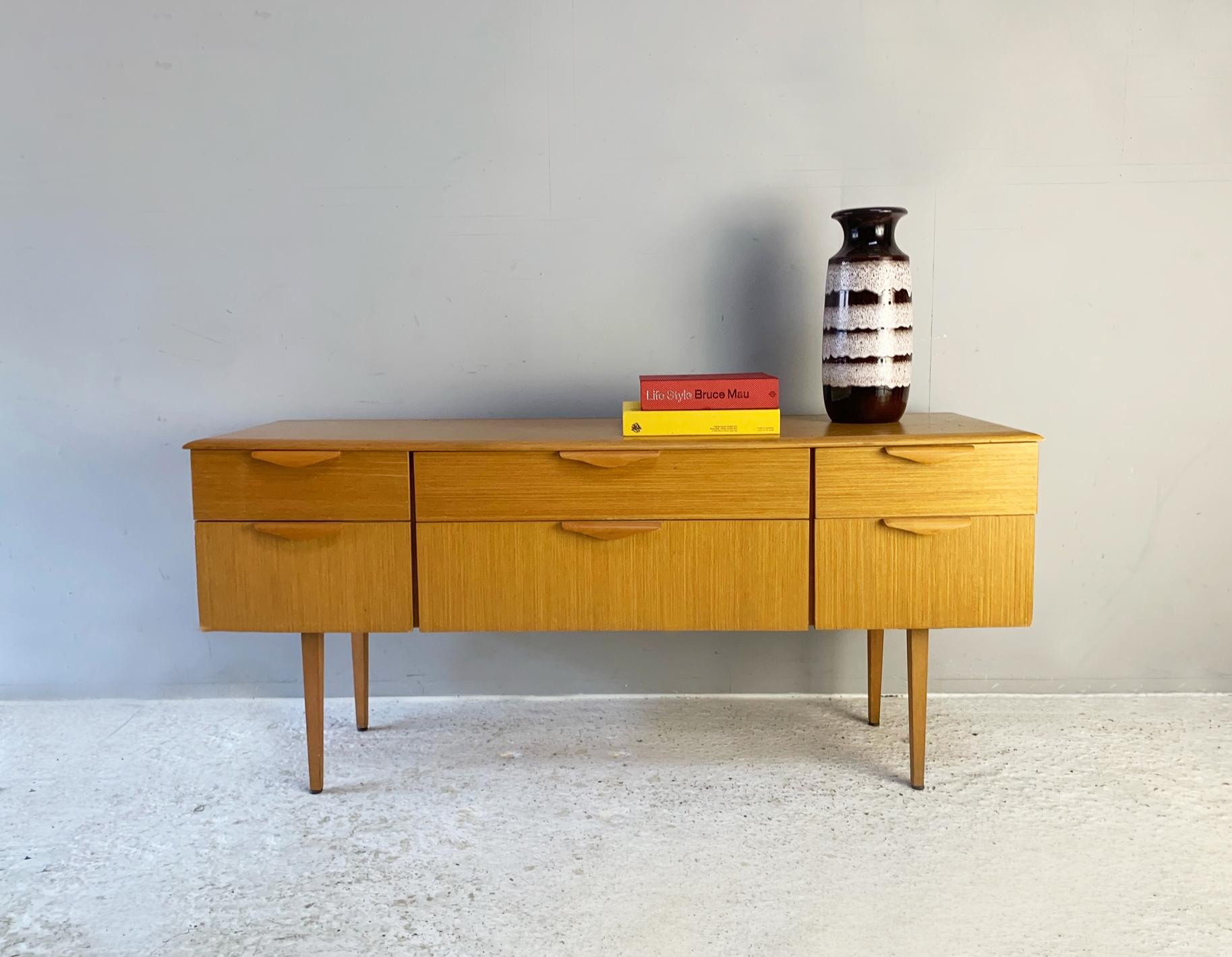 This can be used equally well as a chest of drawers for the bedroom or a sideboard for the living room.

Blonde wood with nicely contoured handles and a bevelled edge top.

Size 
Width 152cm x depth 47cm x height 68cm

Condition:
Very good