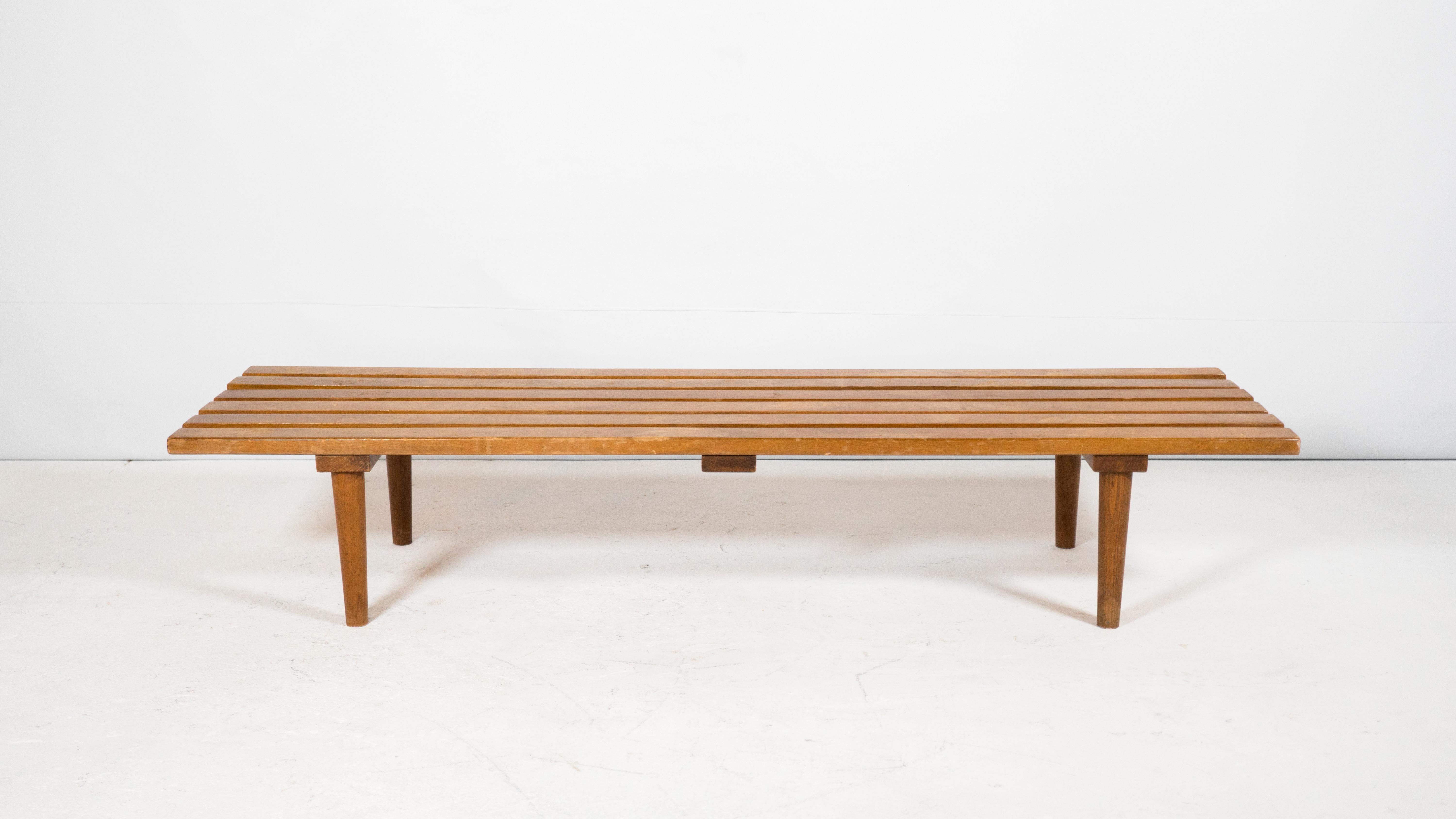Mid Century slat wood bench or coffee table, circa 1960s. Perfect size, long at 5ft, but balanced with a low profile 11 inch height. Constructed of thick wood slats creating a suitable surface for a coffee table. Supported by tapered legs. Good