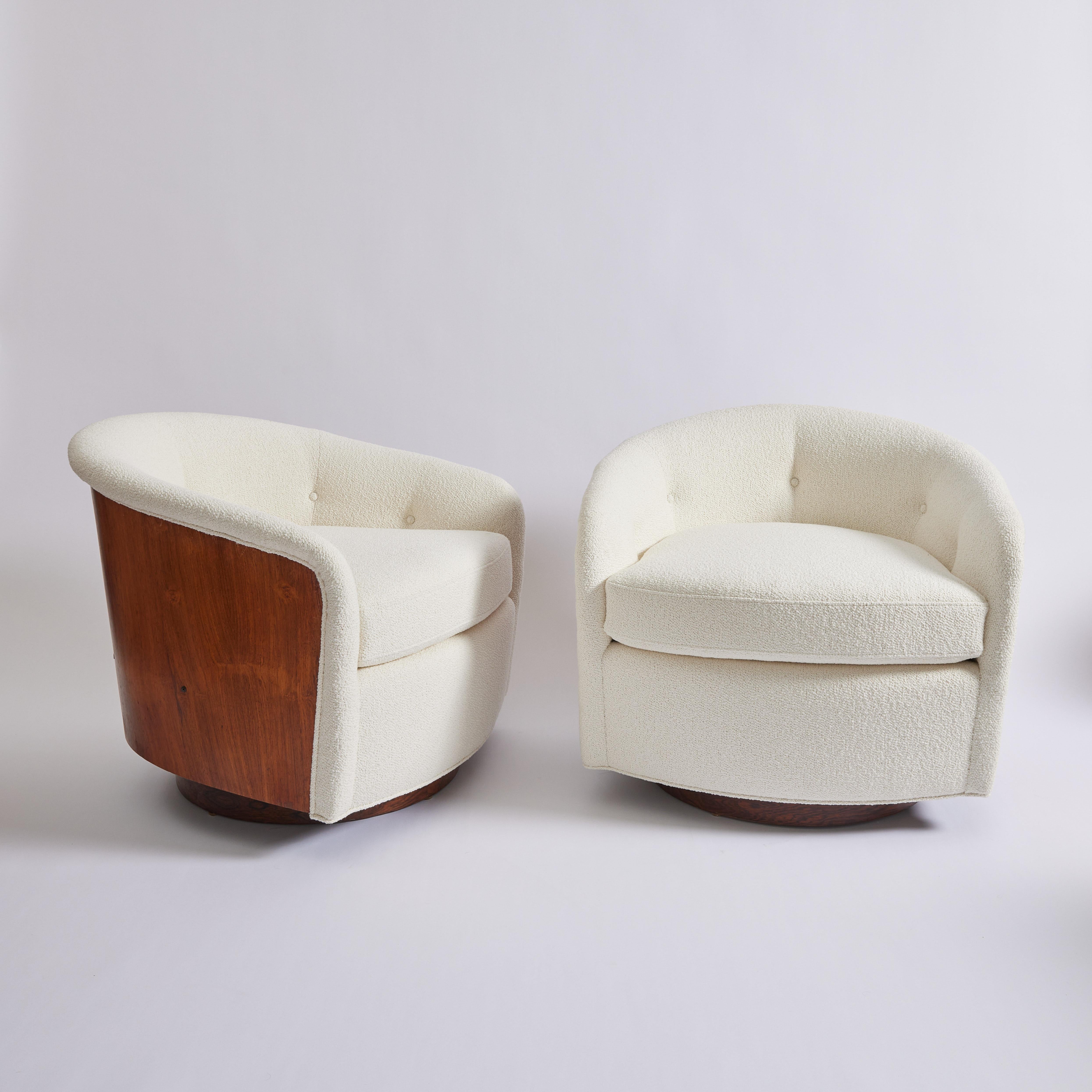 Originally designed in 1965 by Milo Baughman, this swivel and tilt tub chair is a modern classic. The base, back and sides are in walnut, and the rest of the chair has been fully reupholstered. The fabric is a stain resistant Italian boucle and soft