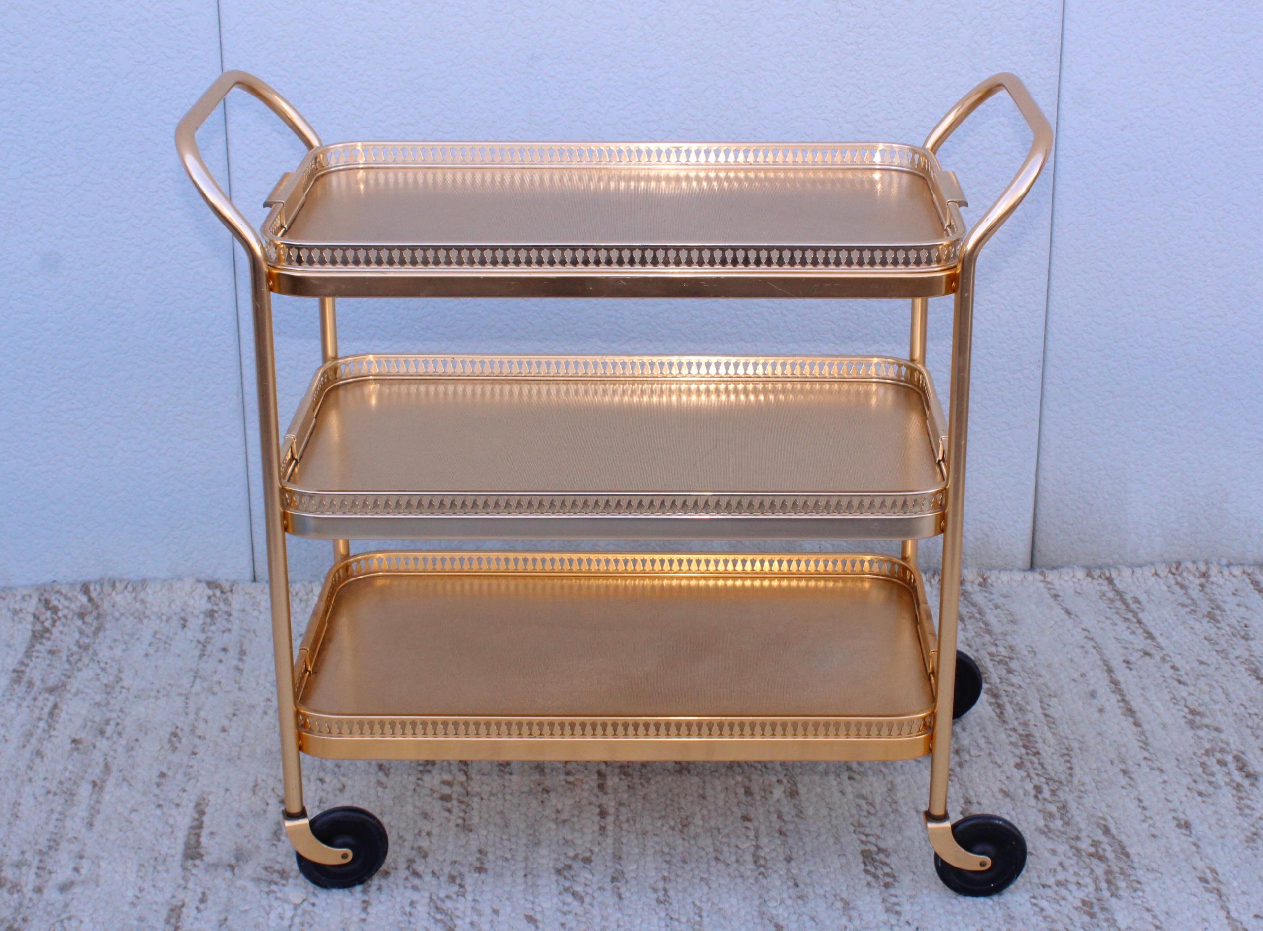 1960's Mid-Century Modern 3 tier bar cart from England made by Kaymet, with removable top tray in vintage original condition with some wear and patina due to age and use.
  