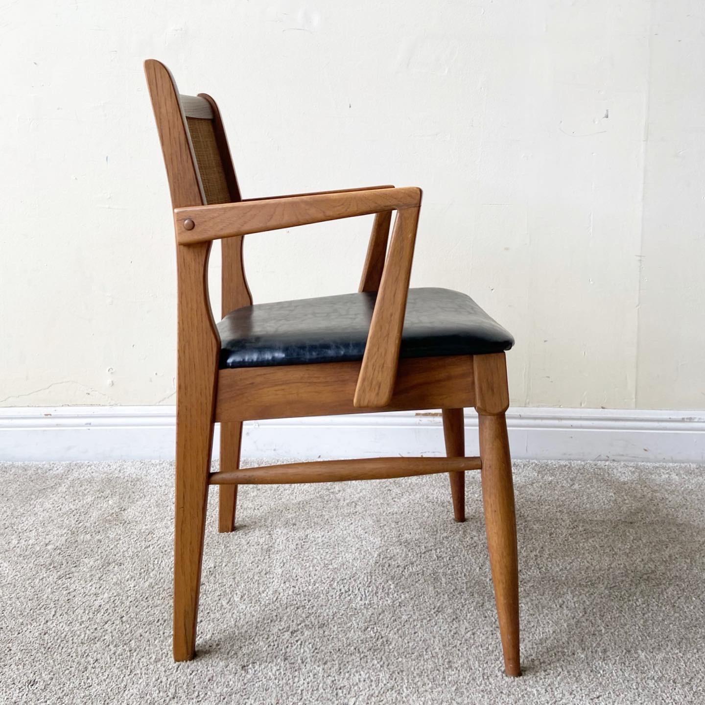Incredible set of 4 Mid-Century Modern dining chairs. There is one arm chair and 3 side chairs.
 