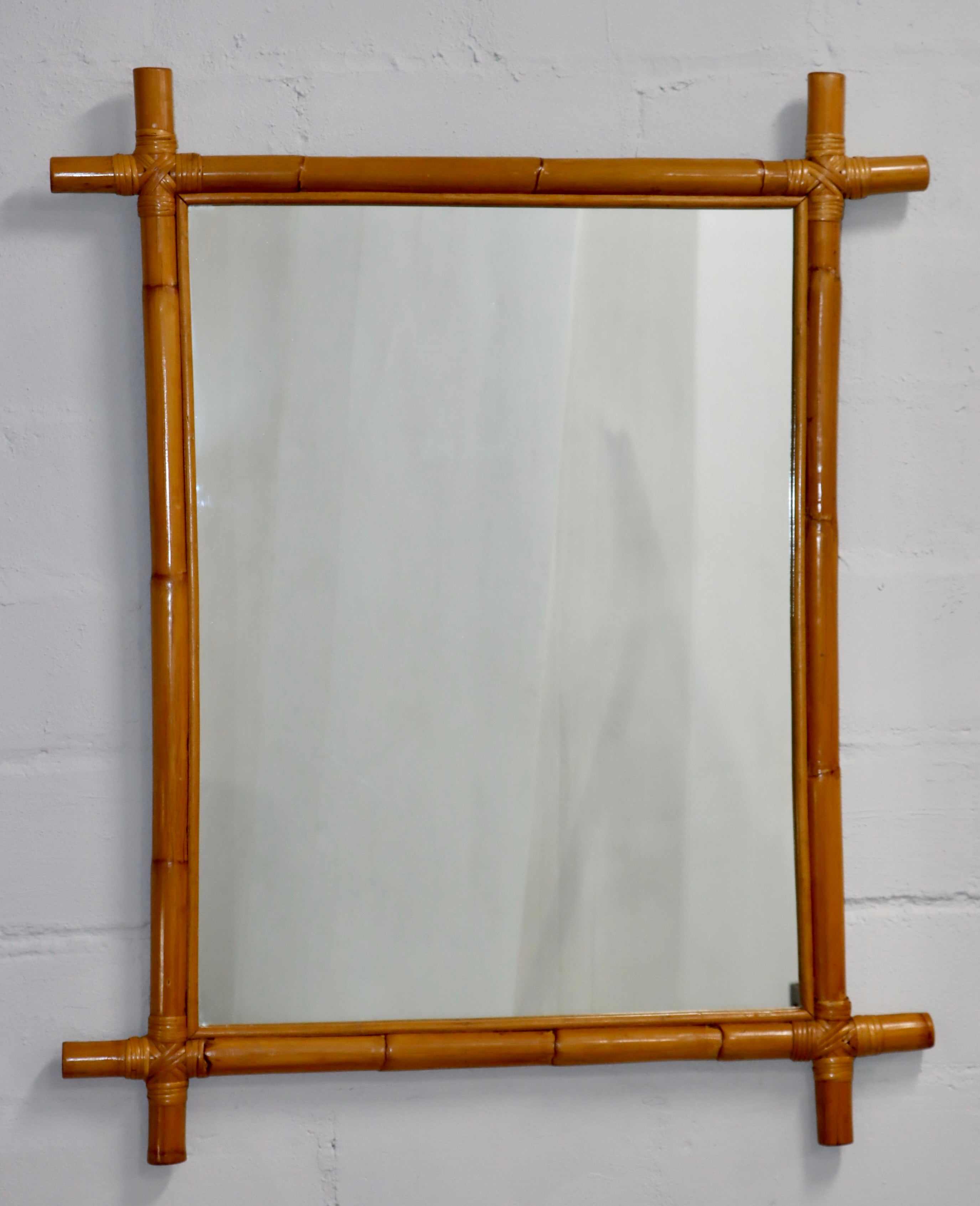 1960's mid-century modern large bamboo and rattan wall mirror, in vintage original condition with minor wear and patina due to age and use.