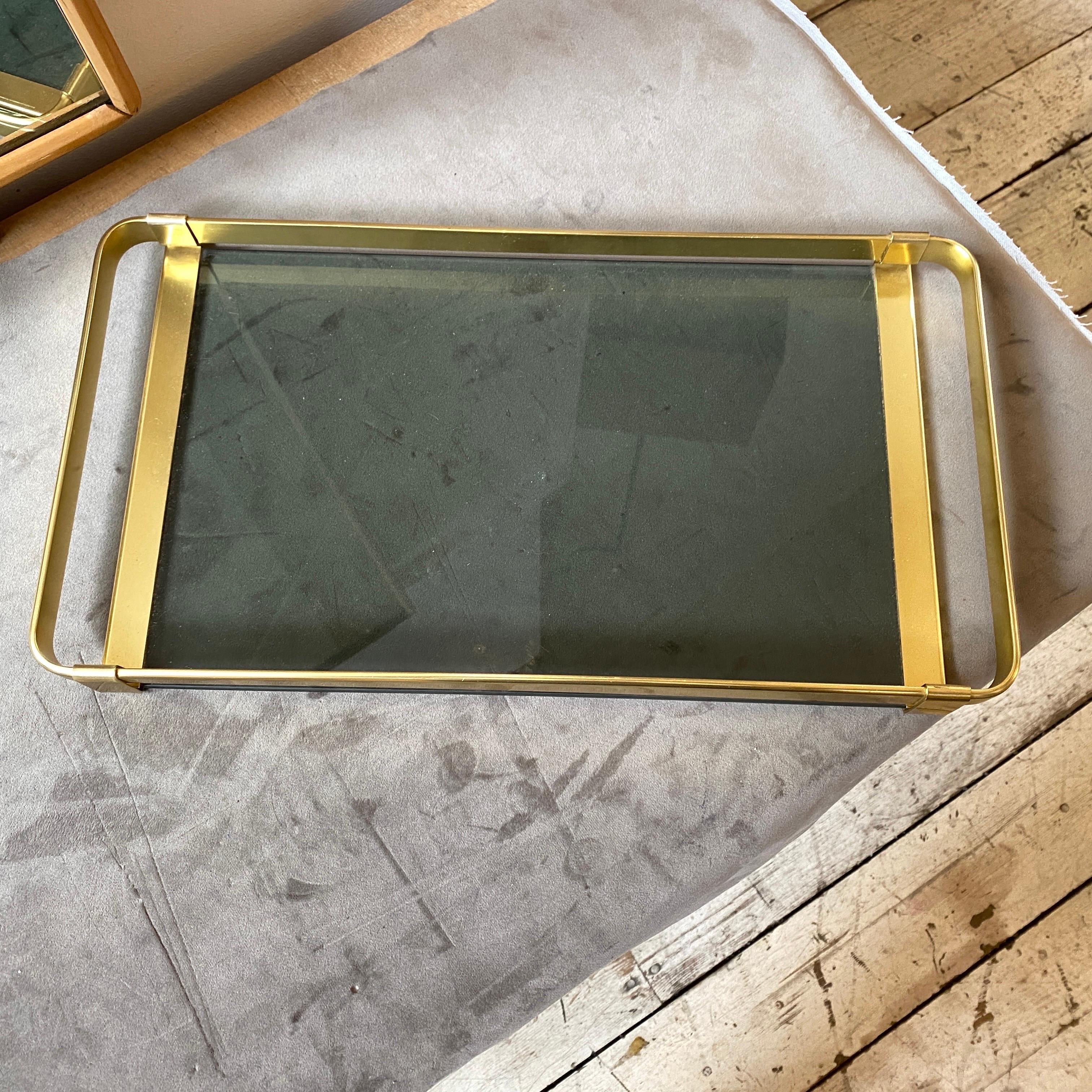 A brass and smoked glass serving tray made in Italy in the Sixties, it's in lovely conditions, probably never used. The brass in original patina gives it a vibrant vintage look.