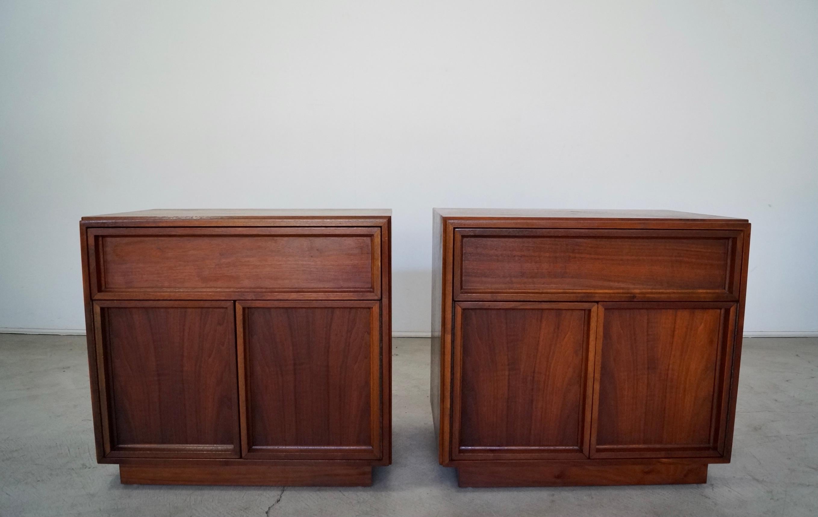 Pair of vintage Mid-Century Modern night stands for sale. Designed by John Keal for Brown Saltman, and still retain the original sticker. They are high-quality pieces with a cabinet that opens up to open storage, and a drawer. They are in amazing