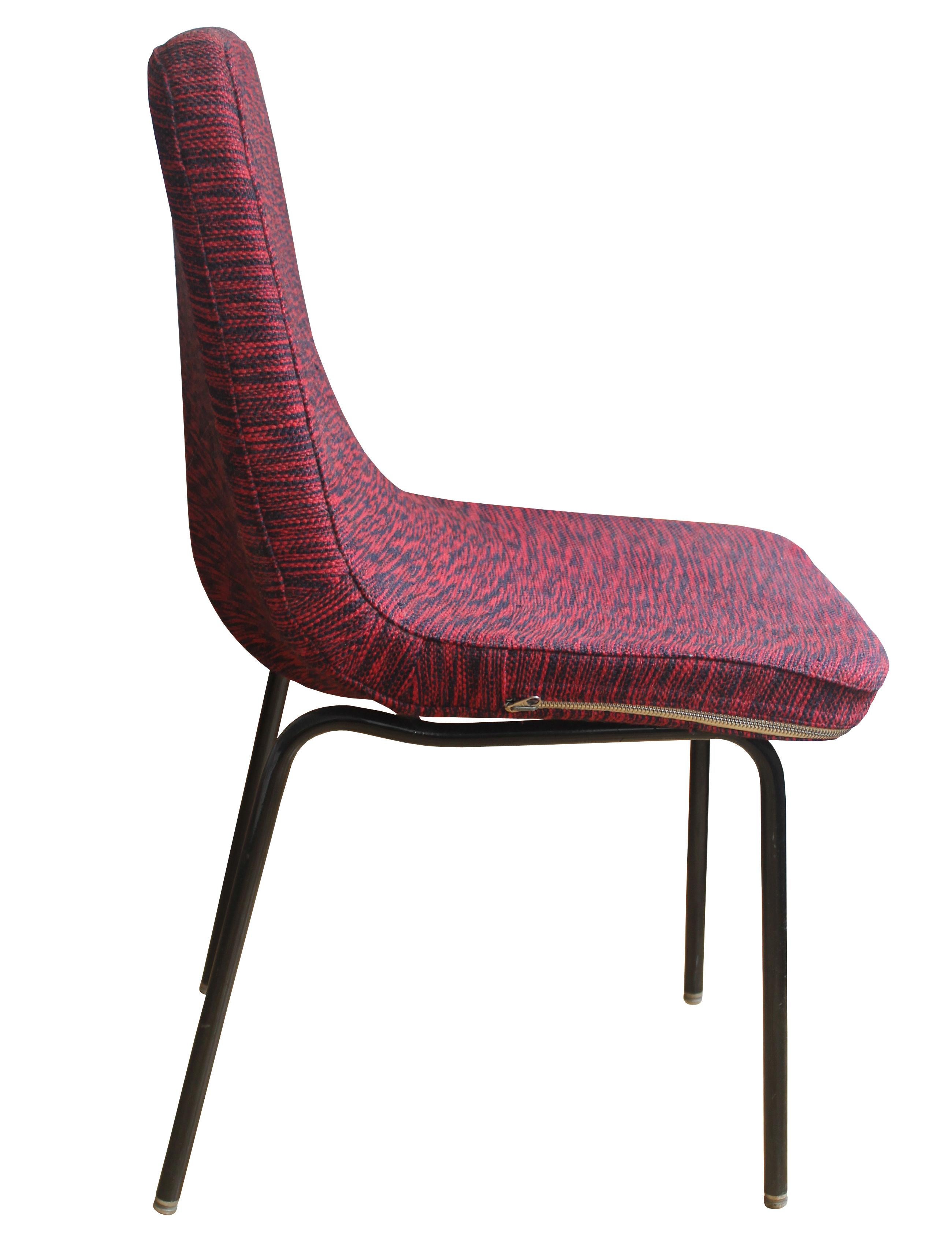 This Mid Century Dining / Office chair was designed in the 1960’s and was most likely produced in one of the factories of former East Germany or Czechoslovakia. The main design feature is the striking fabric cushion with the red and navy blue