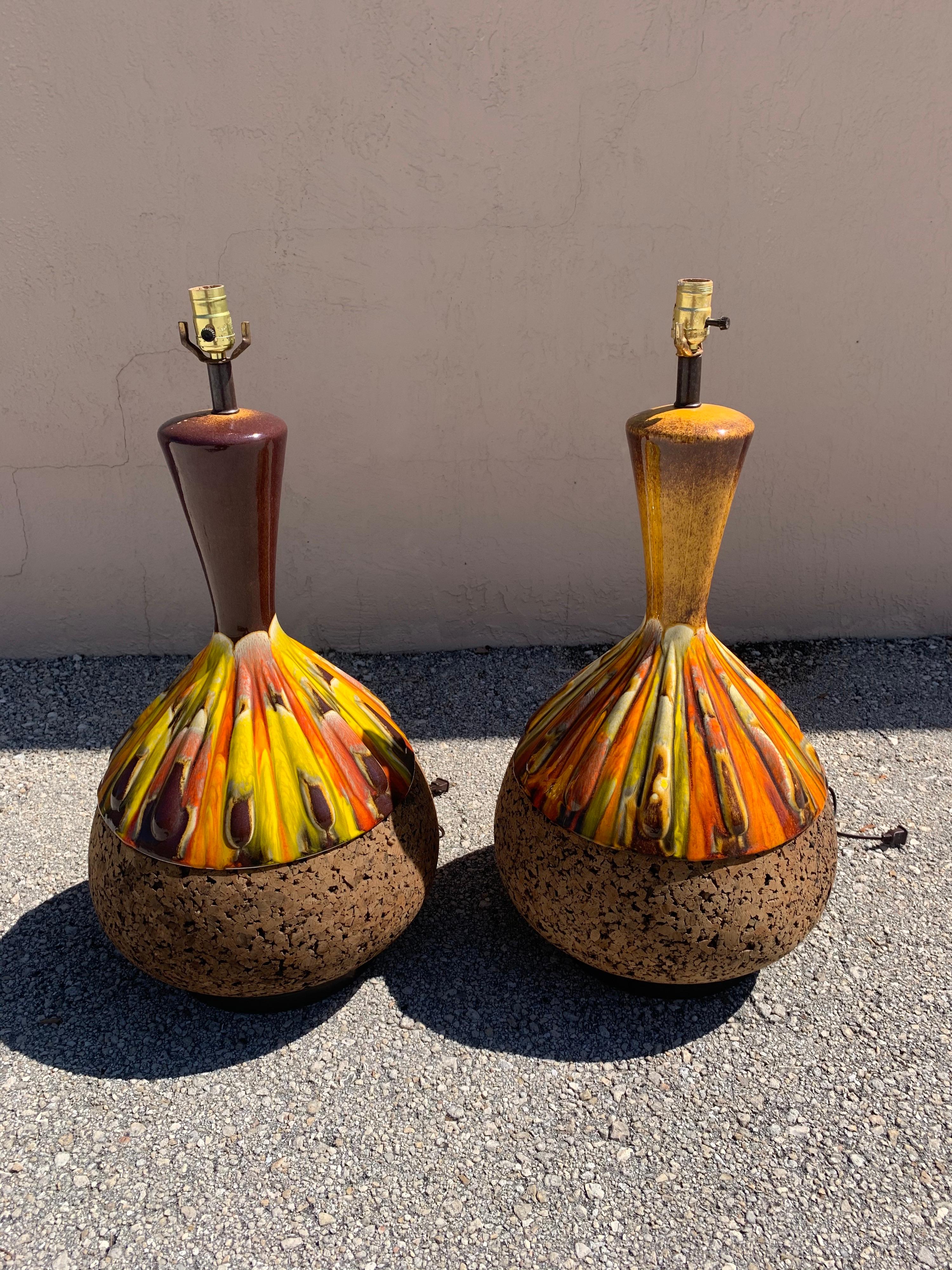 Stellar pair of Mid-Century Modern table lamps in cork and teak. In pristine condition. Gorgeous browns, yellows, and oranges swirling in the ceramic.