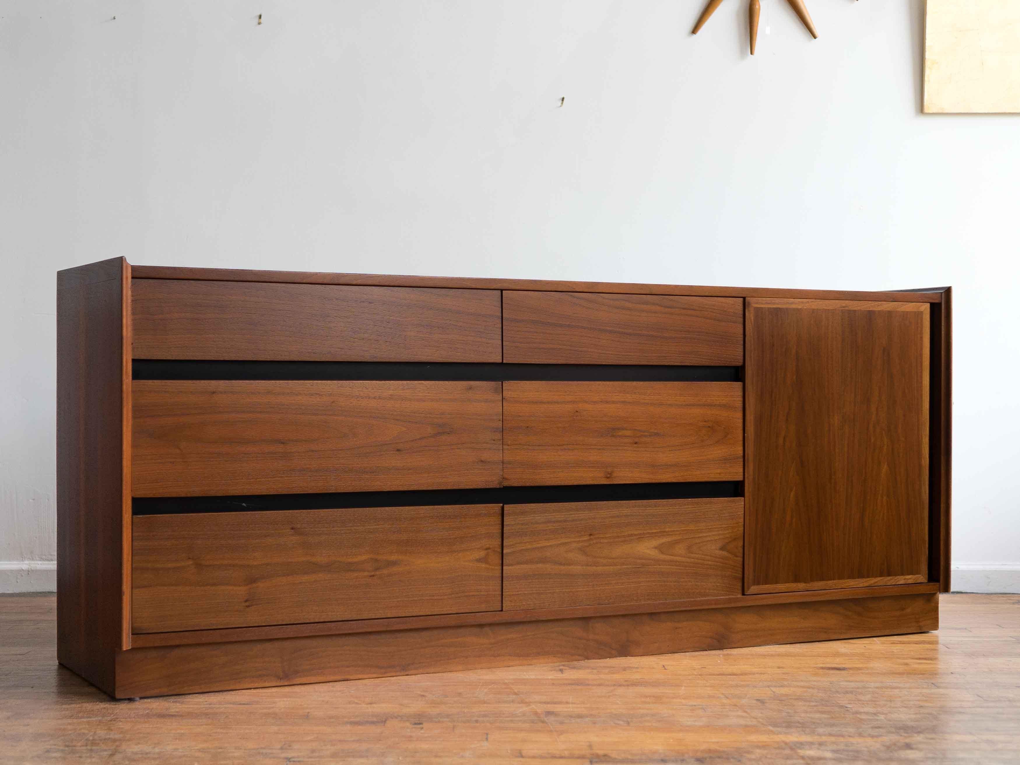 Please inquire for shipping rates. 

72” x 18.5” x 29.5”H

Classing 9 drawer lowboy designed by Merton Gershun for Dillingham's Esprit line. Walnut body and drawers with figured grain running continuously across the drawer fronts; black lacquered