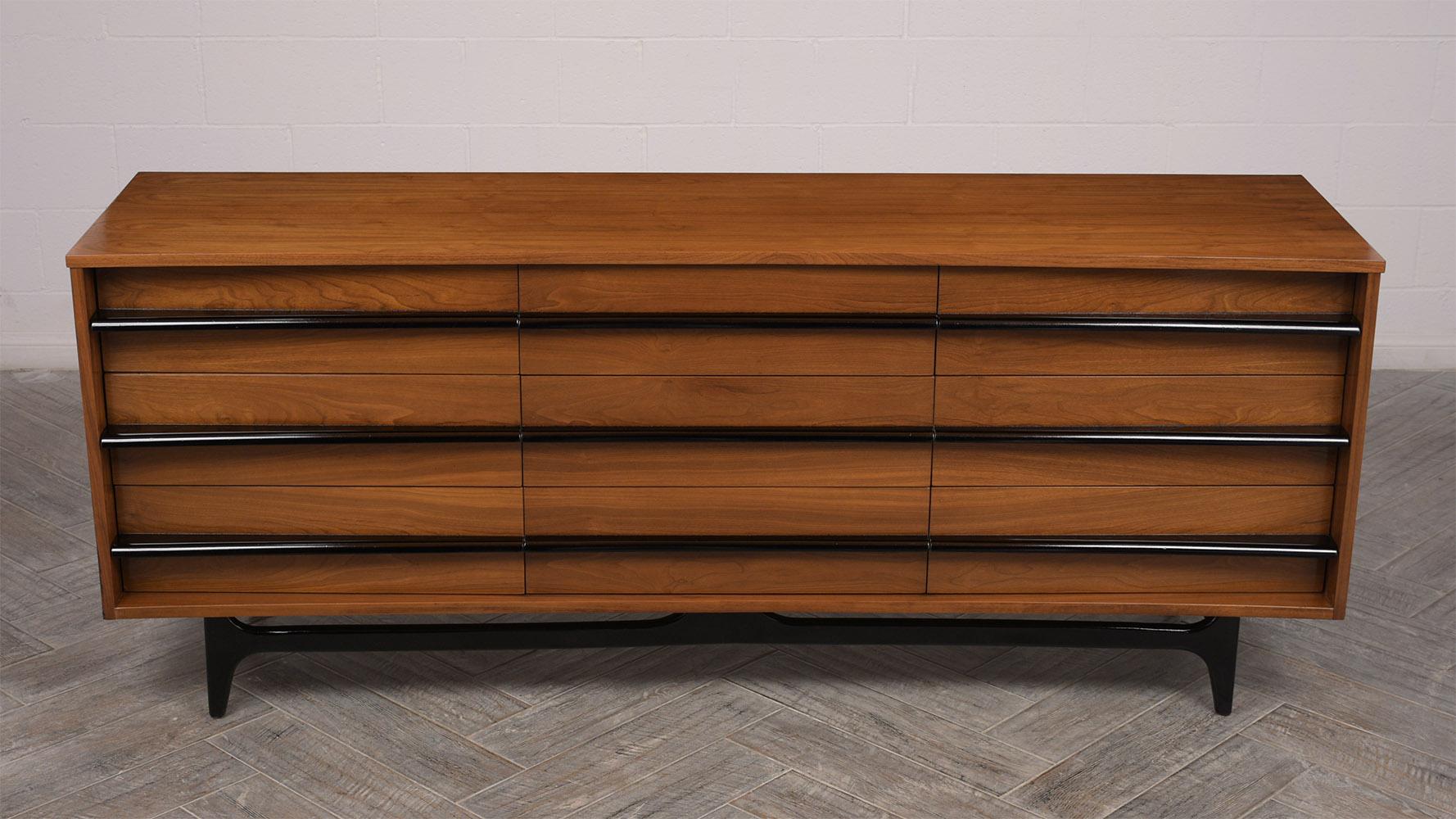 This is a unique dresser in the style of American designer Vladimir Kagan. Made from solid walnut wood, stained in a light walnut color. Features clean lines with a unique front curved design. Has nine drawers with black color handles. Top right