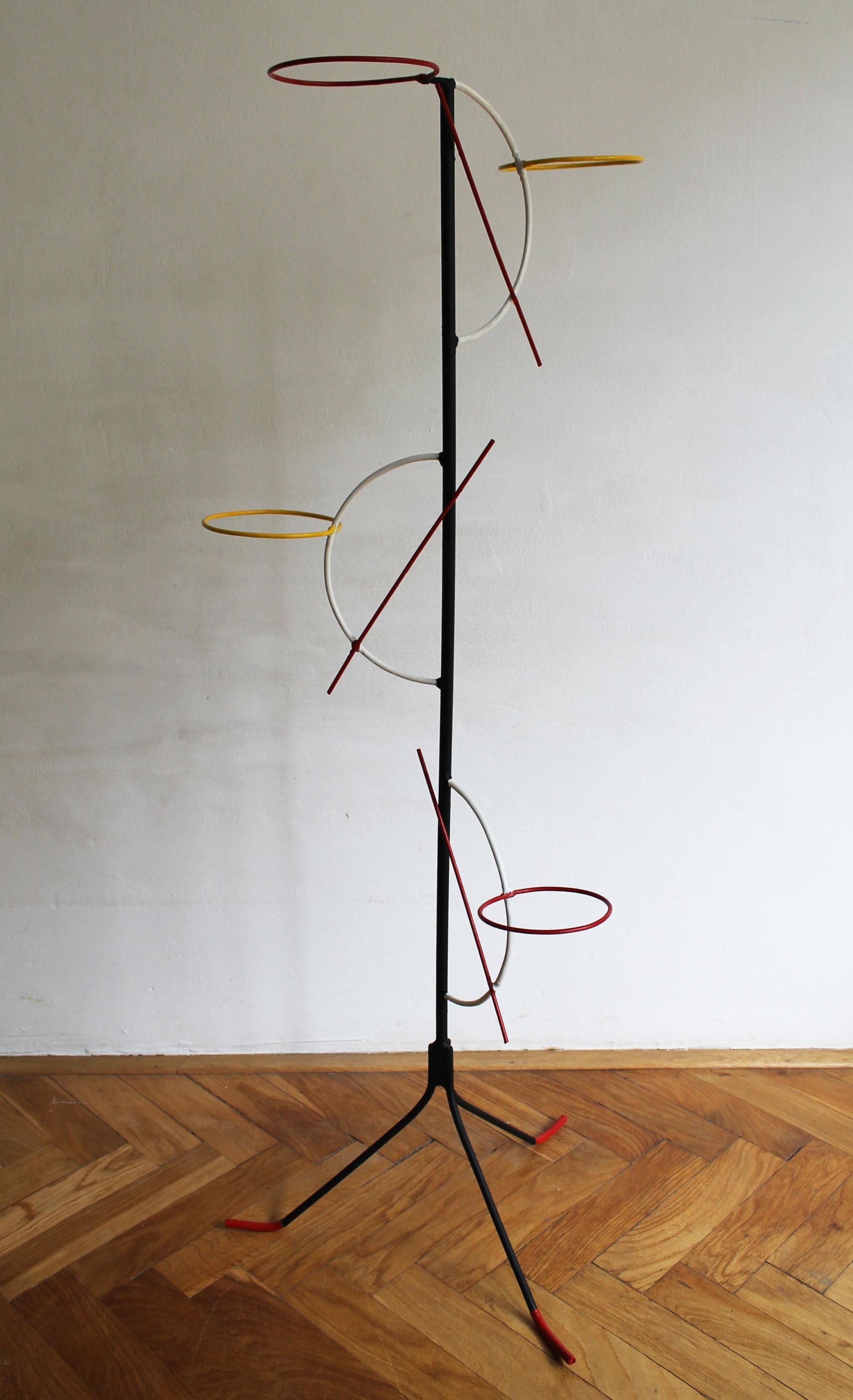 Original 1960’s Mid Century Modern Flower stand. A delightful composition of black painted steel frame standing on a tripod with four round flower holders at different heights and in different colours (red and yellow).  One holder is fixed directly
