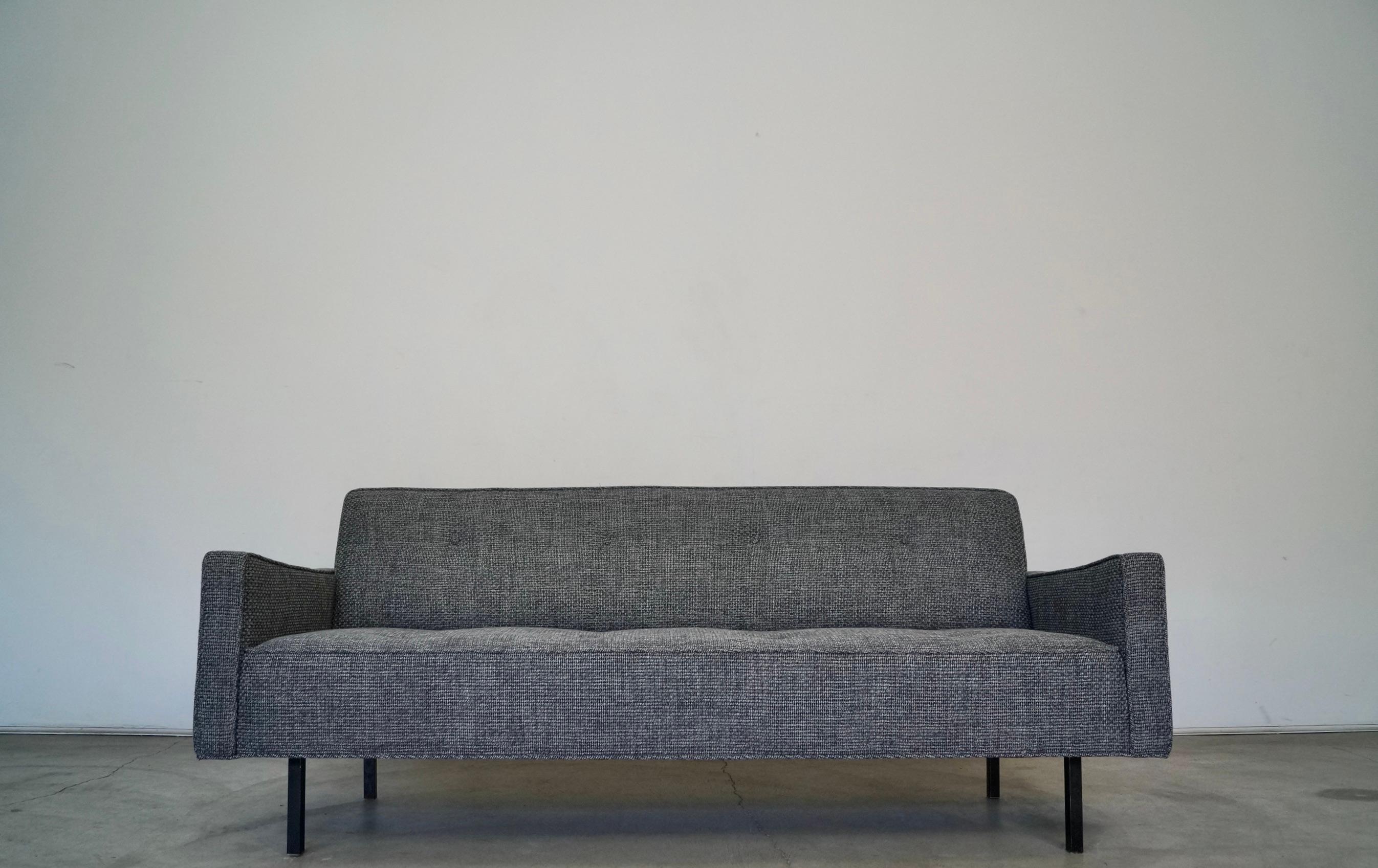 Vintage 1960s Mid-Century Modern couch for sale. It has been professionally reupholstered in new tweed and foam, and is in restored condition. It has a beautiful frame with incredible lines in the manner of George Nelson for Herman Miller. It sits