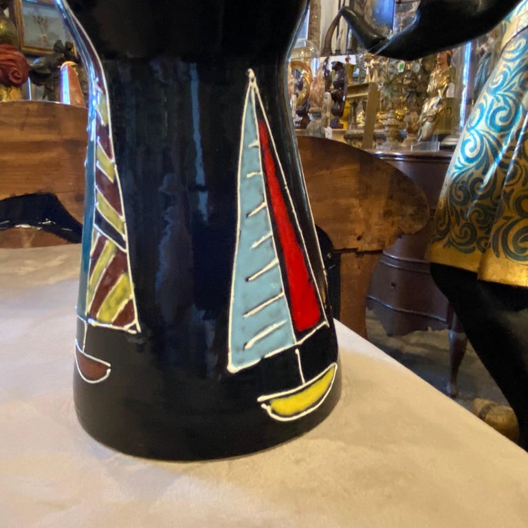 A red and black ceramic vase decorated with sail boats made in Italy in the Sixties by Bini & Carmignani, signed on the bottom.