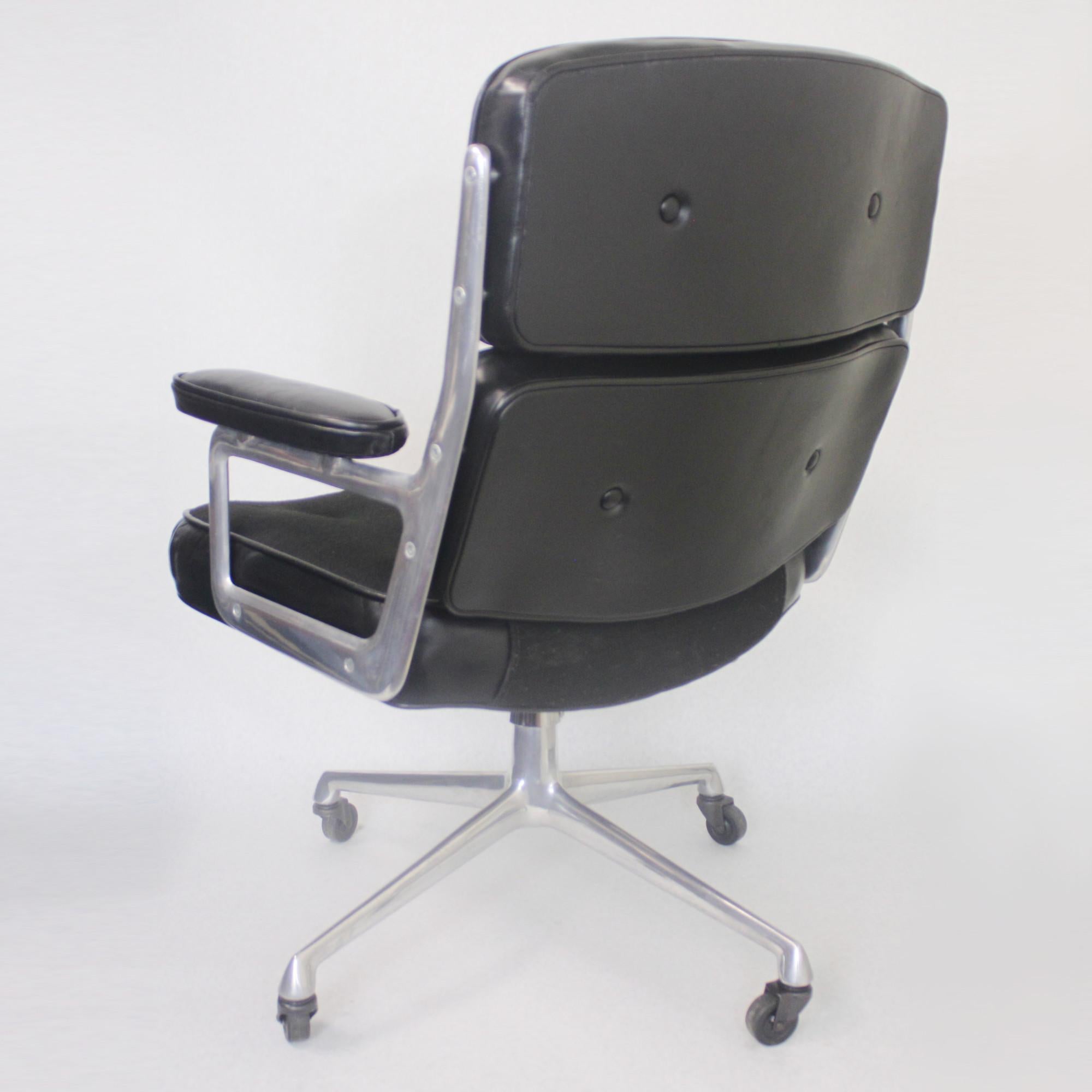 Spectacular 1960s, Herman Miller executive chair originally designed by Charles Eames for New York's Time life building. Chair features a polished aluminium frame, black tufted leather upholstery with black tufted cloth seat insert. Chair tilts,