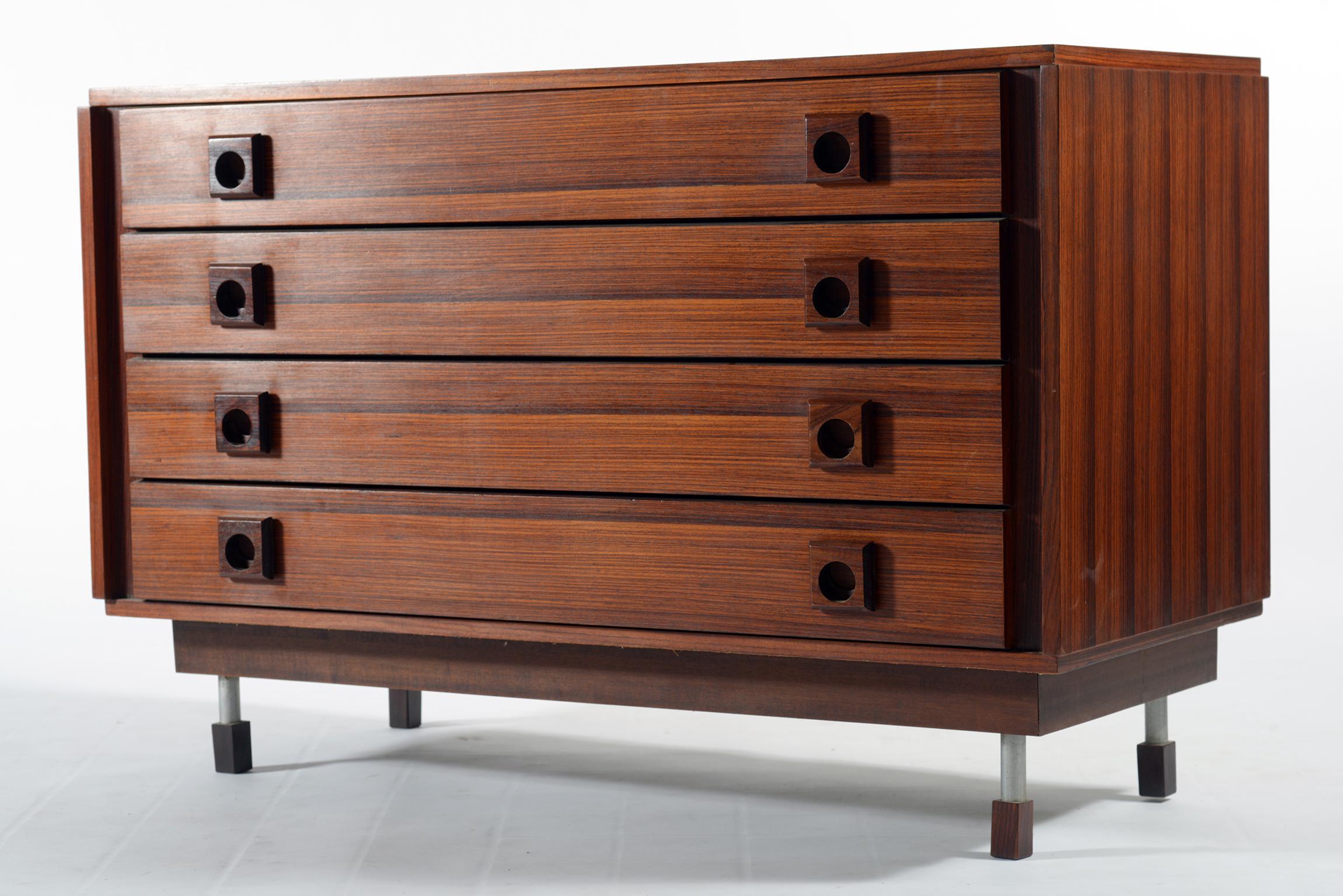 Italian midcentury precious exotic wood chest of drawers with solid sculptured wood handless, metal and wood legs,
1960s.