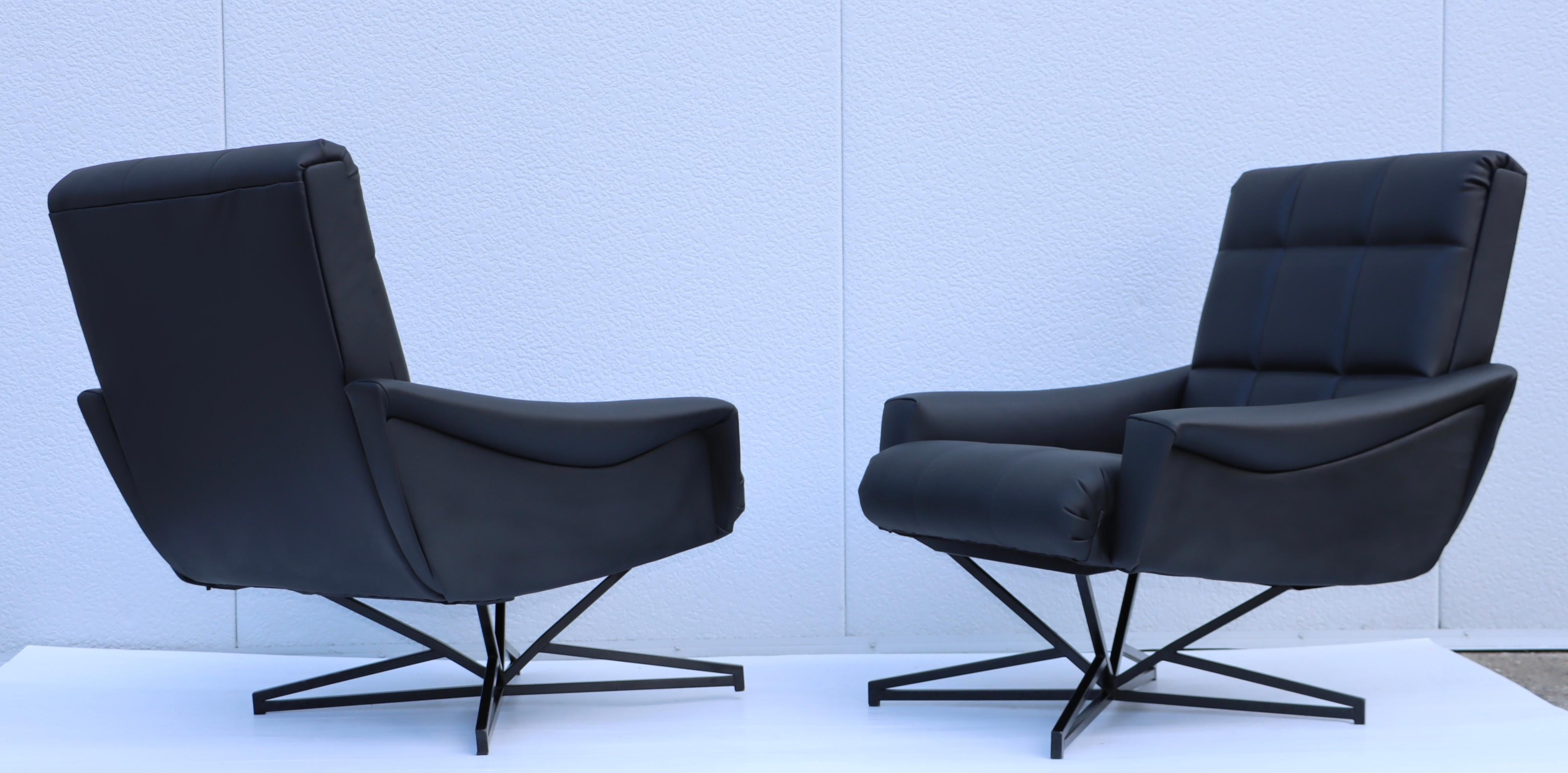 Stunning pair of 1960's Mid-Century Modern leather upholstery with iron base lounge chairs by Forma Nova, fully restored with minor wear and patina due to age and use.
