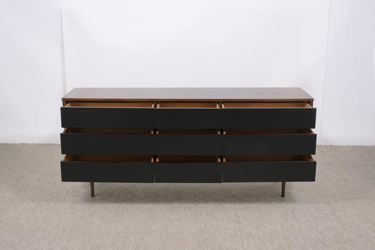 An extraordinary vintage 1960s mid-century modern lacquered chest of drawers that is hand-crafted out of walnut wood in great condition and has been professionally restored by our team of expert craftsmen. This piece is an eye-catching addition to