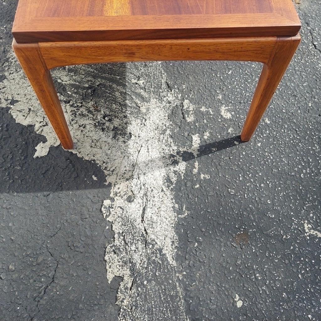 This vintage 1967 Lane coffee table from the Rhythm Series is representative of the Mid Century Modern era with its, minimal lines and a formidable profile accented by a clean walnut finish. This piece has been professionally refinished to bring out