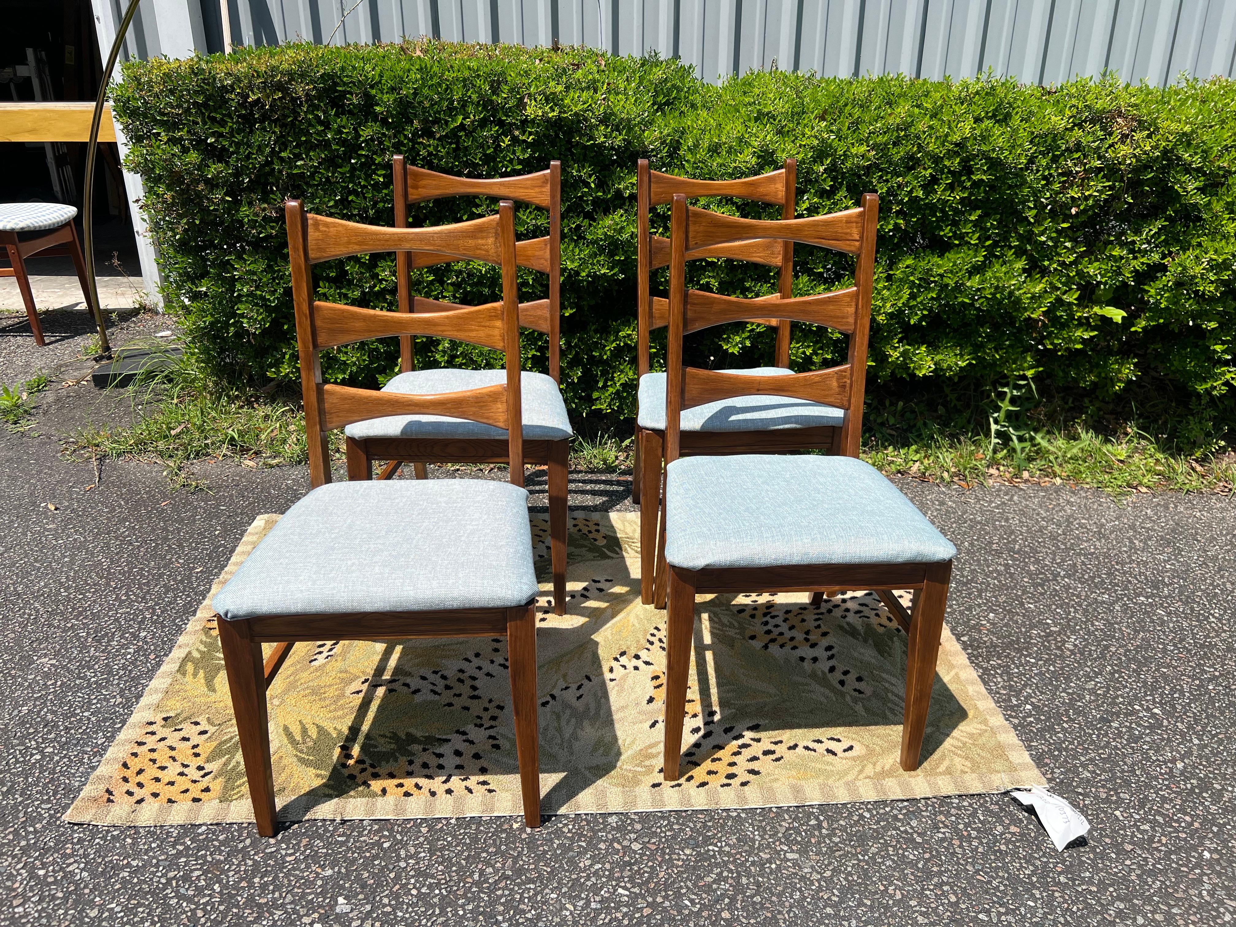 This listing is for a set of four Mid-Century Modern Lane Rhythm Dining Chairs. Featuring a ribbon back design, four side chairs, solid wood frames, newly upholstered seats, and a beautiful walnut finish. This is an exceptional combination of