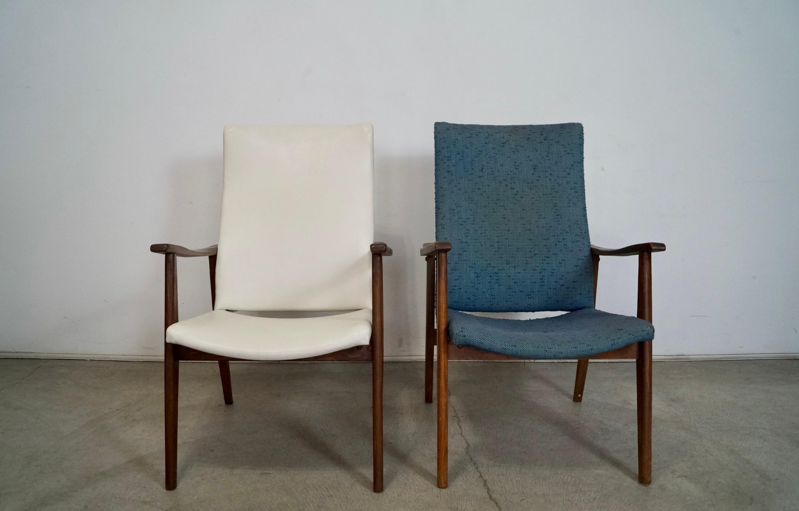 Pair of vintage all original Midcentury Modern lounge armchairs for sale. They have a solid wood frame in a walnut finish. One of them has the original white naugahyde vinyl and the other in a teal nubby fabric. The wood in the white one is in