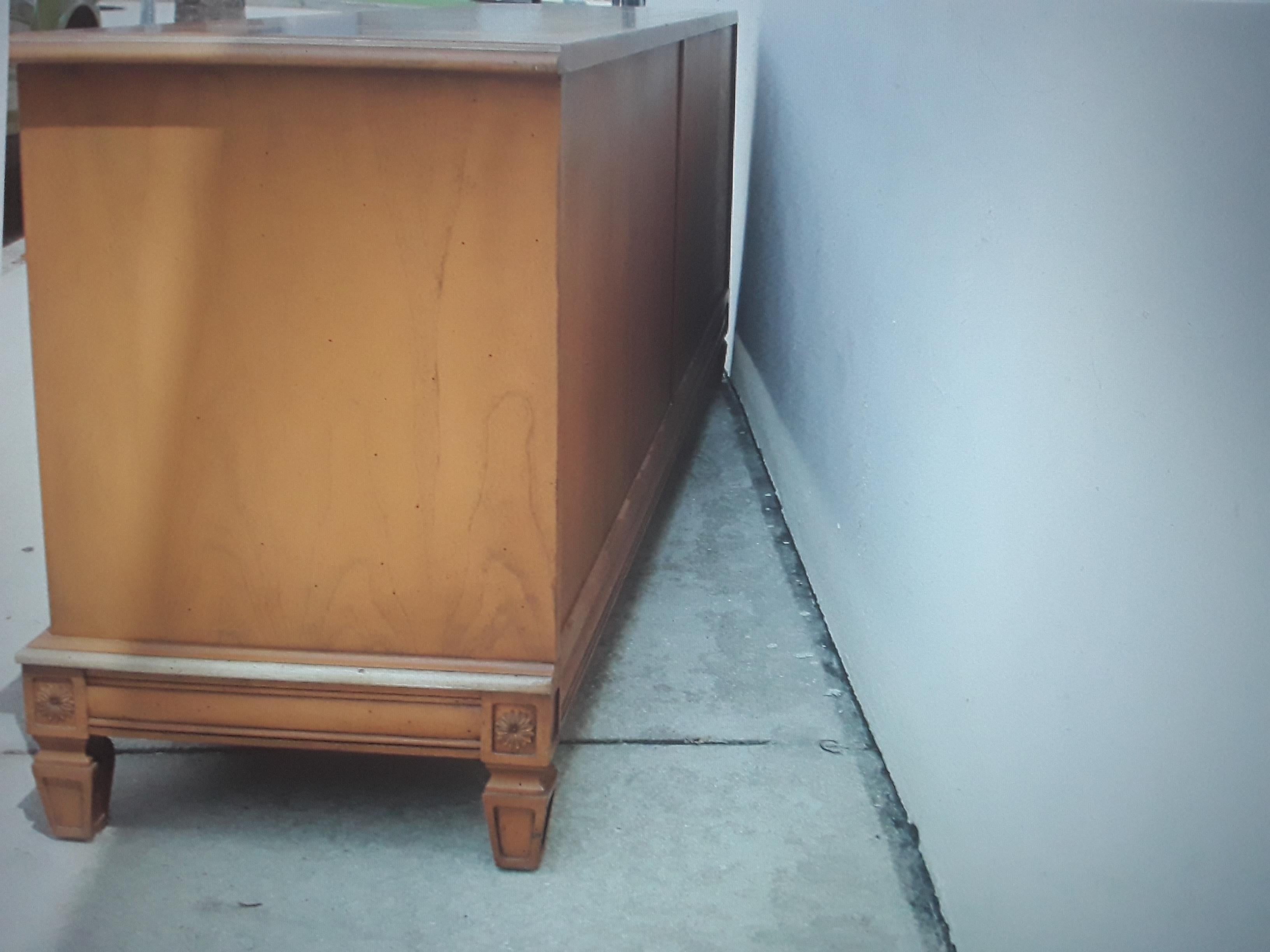 Beautiful 1960's Mid Century Modern Low Sideboard/ Buffet/ Credenza/ Dry Bar. This buffet is in an orange brown tone. Lovely buffet!