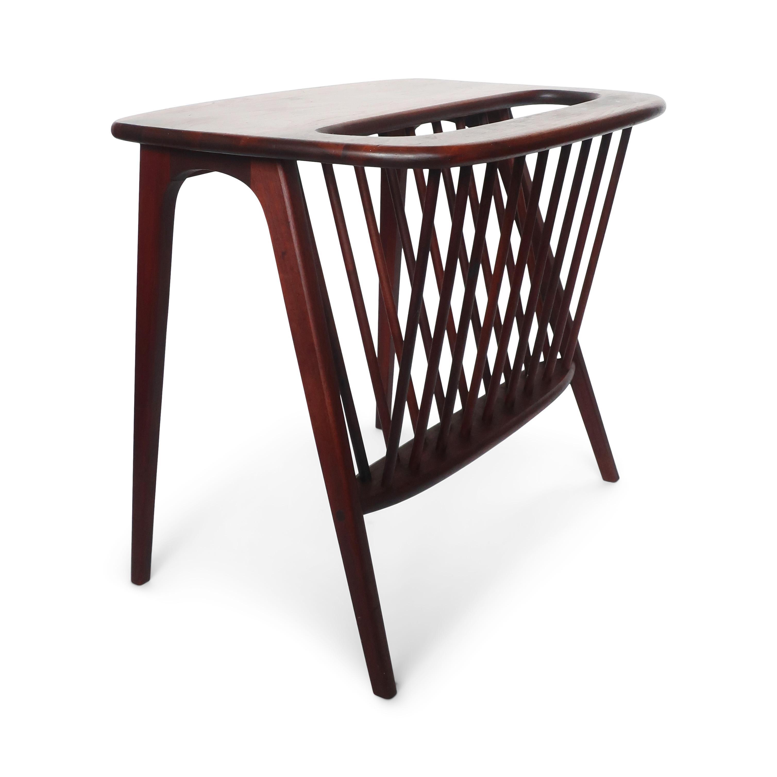A stunning solid wood Arthur Umanoff style magazine rack side table, likely in walnut or teak. With an organically shaped frame, table top, and legs, this table highlights the vibrant grain pattern on the table's surface and allows for ample storage