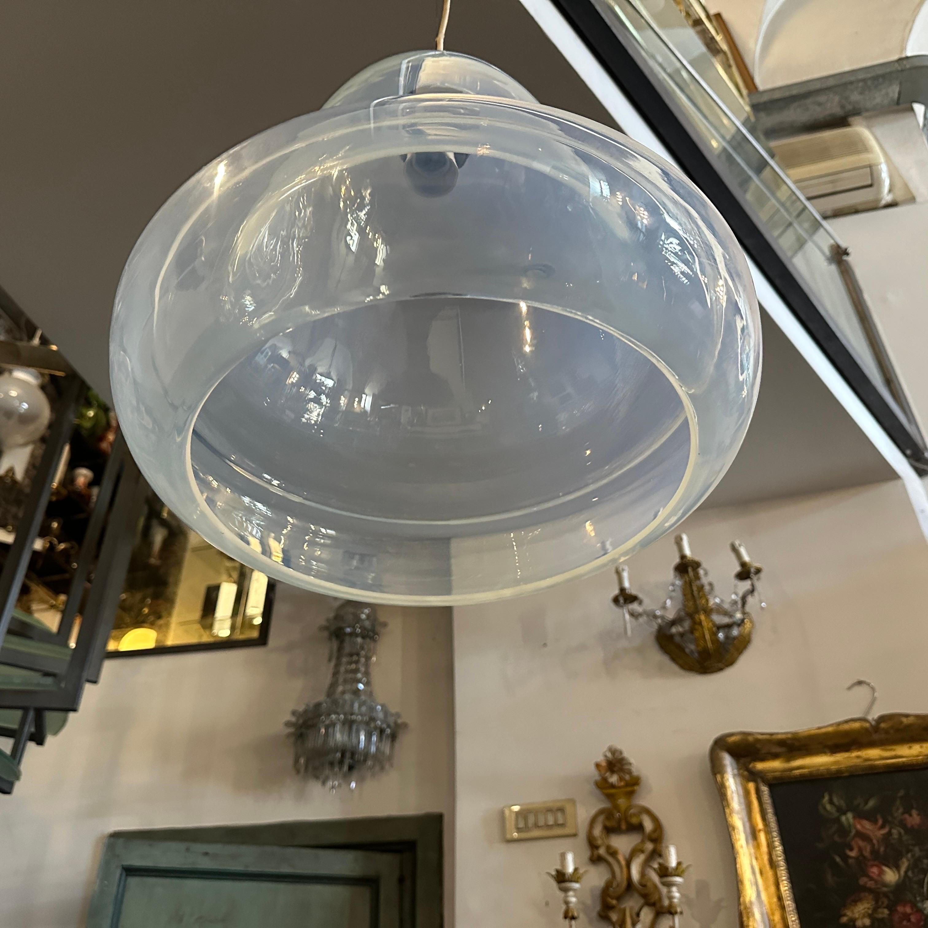 This is a 1960s Mid-Century Modern Murano glass pendant light, crafted with a distinct opalescent finish. The design showcases a bell-like shape with smooth, curving lines and a clear, slightly bluish hue, which allows light to diffuse softly