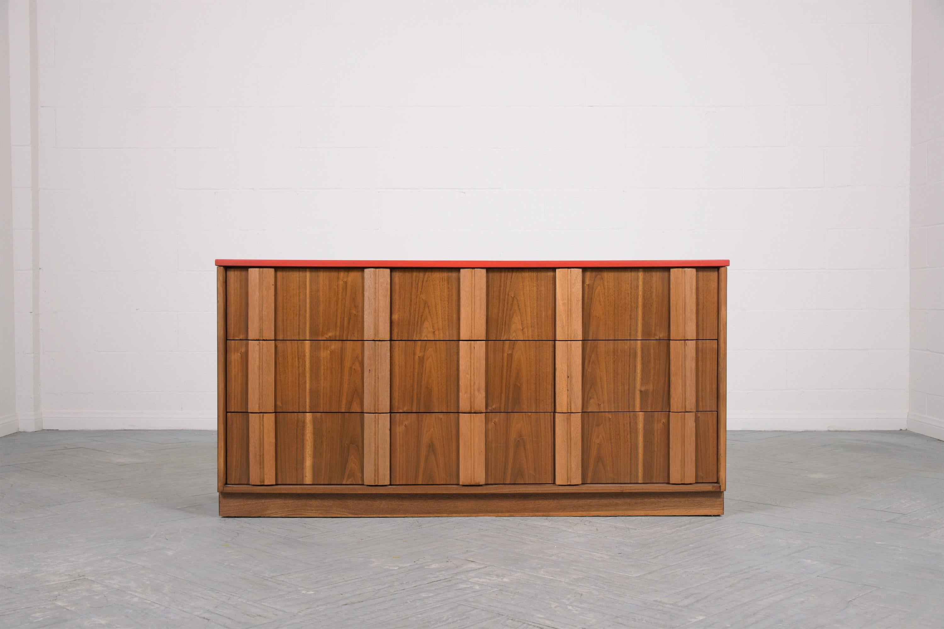 Dive into the retro allure of our mid-century modern chest of drawers, a masterful creation from the 1960s. Expertly hand-crafted from premium walnut wood, this vintage gem has been rejuvenated to its former glory by our team of skilled craftsmen.