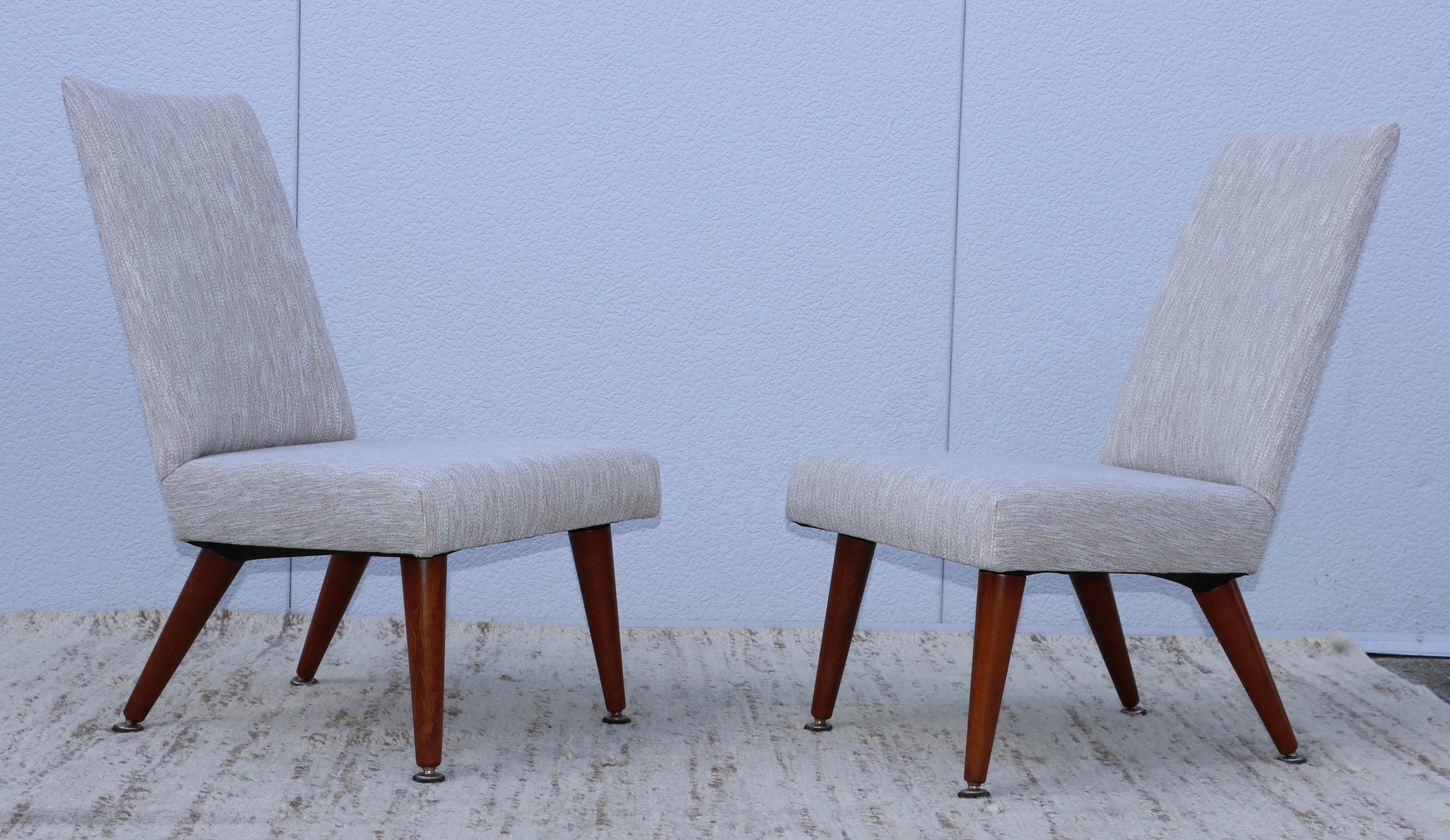 1960's Mid-Century Modern petite slipper chairs with solid walnut legs and Donghia fabric upholstery, fully restored and re-upholstered with minor wear and patina due to age and use.