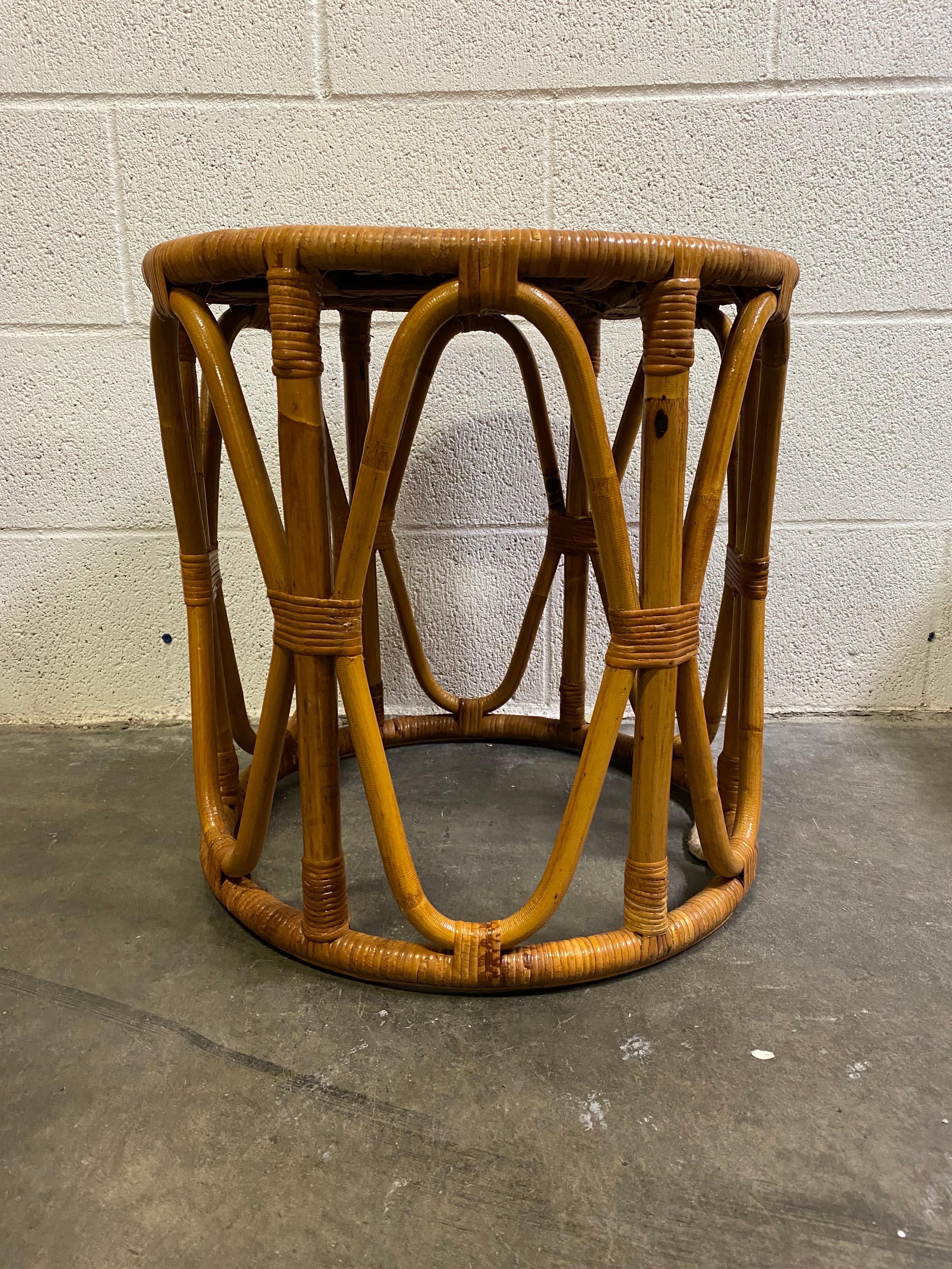 For sale we have a 1970s vintage tiki style or boho chic Mid-Century Modern rattan and bamboo side table which can also perfectly used as a stool or plant stand. This will add a great mid century boho accent to any room or space.

Structurally in