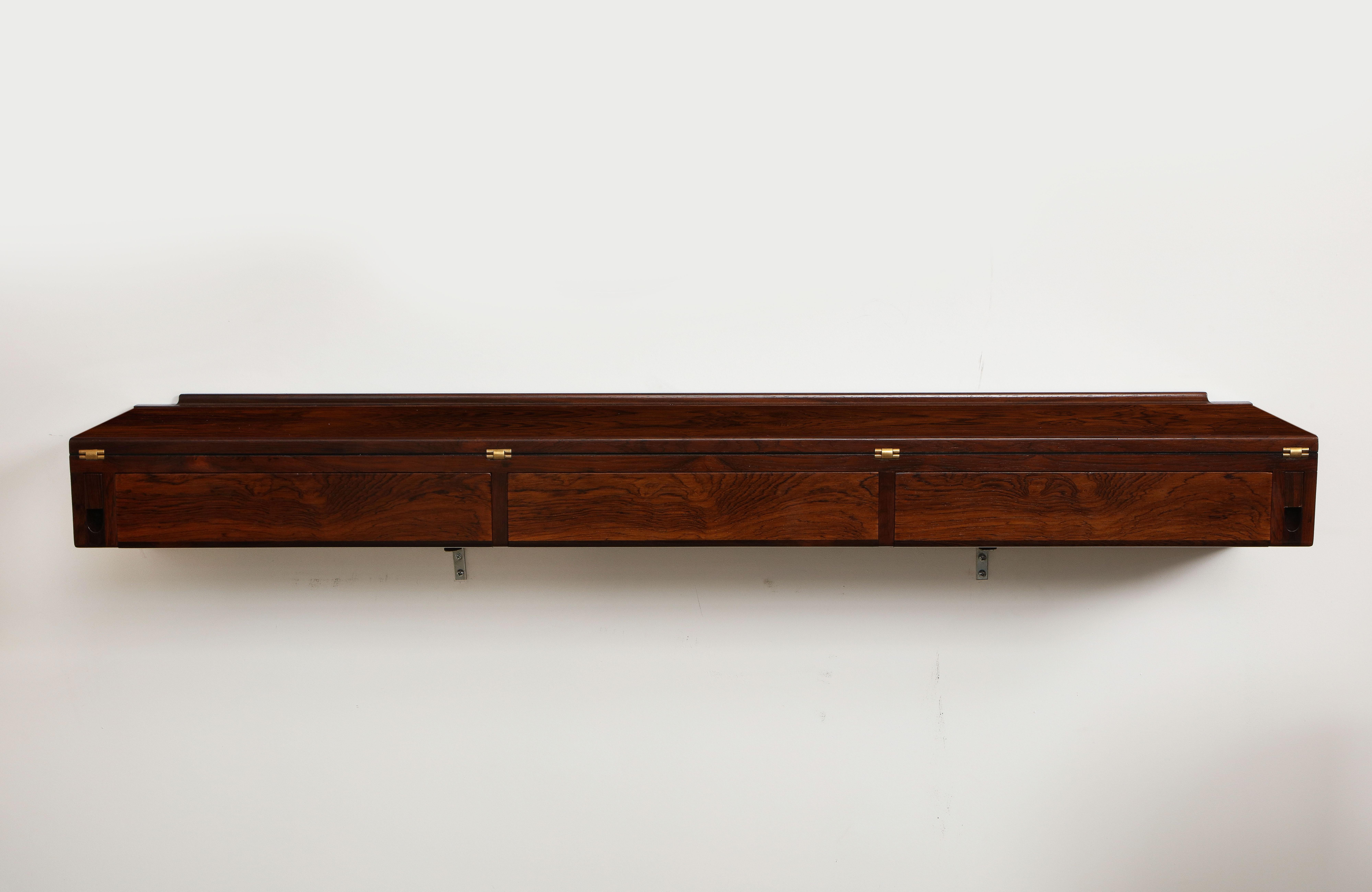 Stunning 1960's Mid-Century Modern rosewood wall-mounted desk designed by Arne Hovmand Olsen, with brass hardware and laminate flip top, fully restored with minor wear and patina due to age and use.