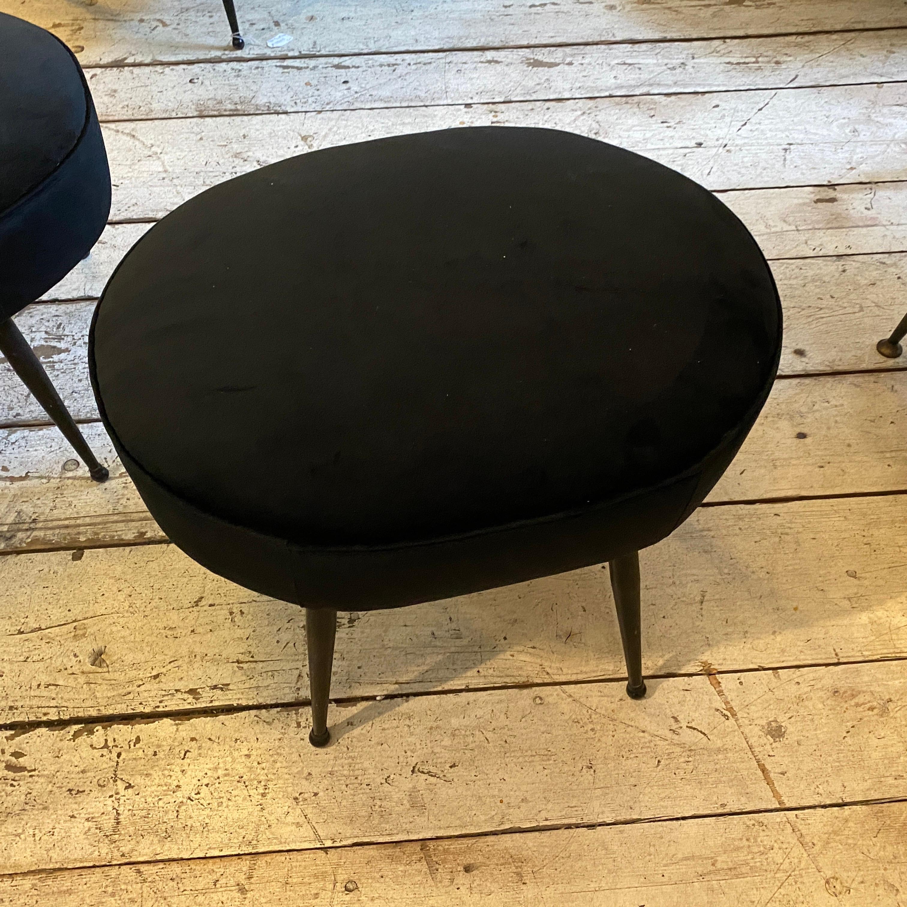Two upholstered black velvet and metal oval poufs made in Italy in the sixties, they are in perfect conditions.
