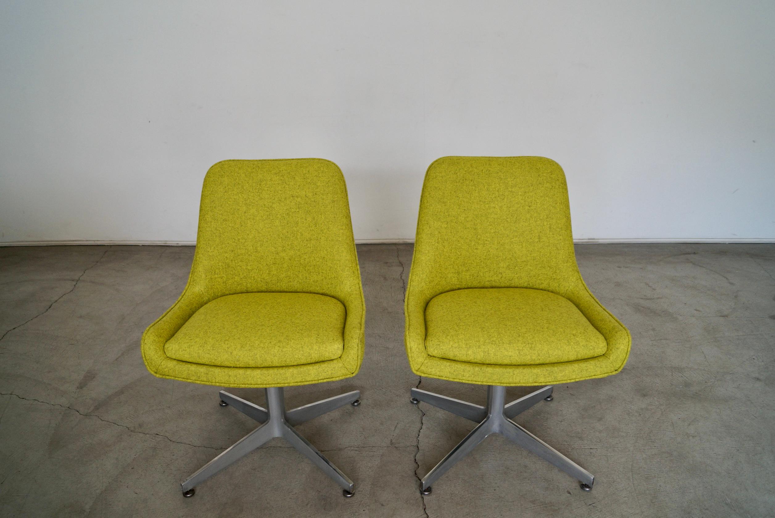 Vintage Mid-Century Modern lounge chairs for sale. They are from the 1960's, and have been professionally reupholstered in Camira's designer fabric in Blazer that goes for $54 a yard. The fabric is an electric green with black undertones, and is