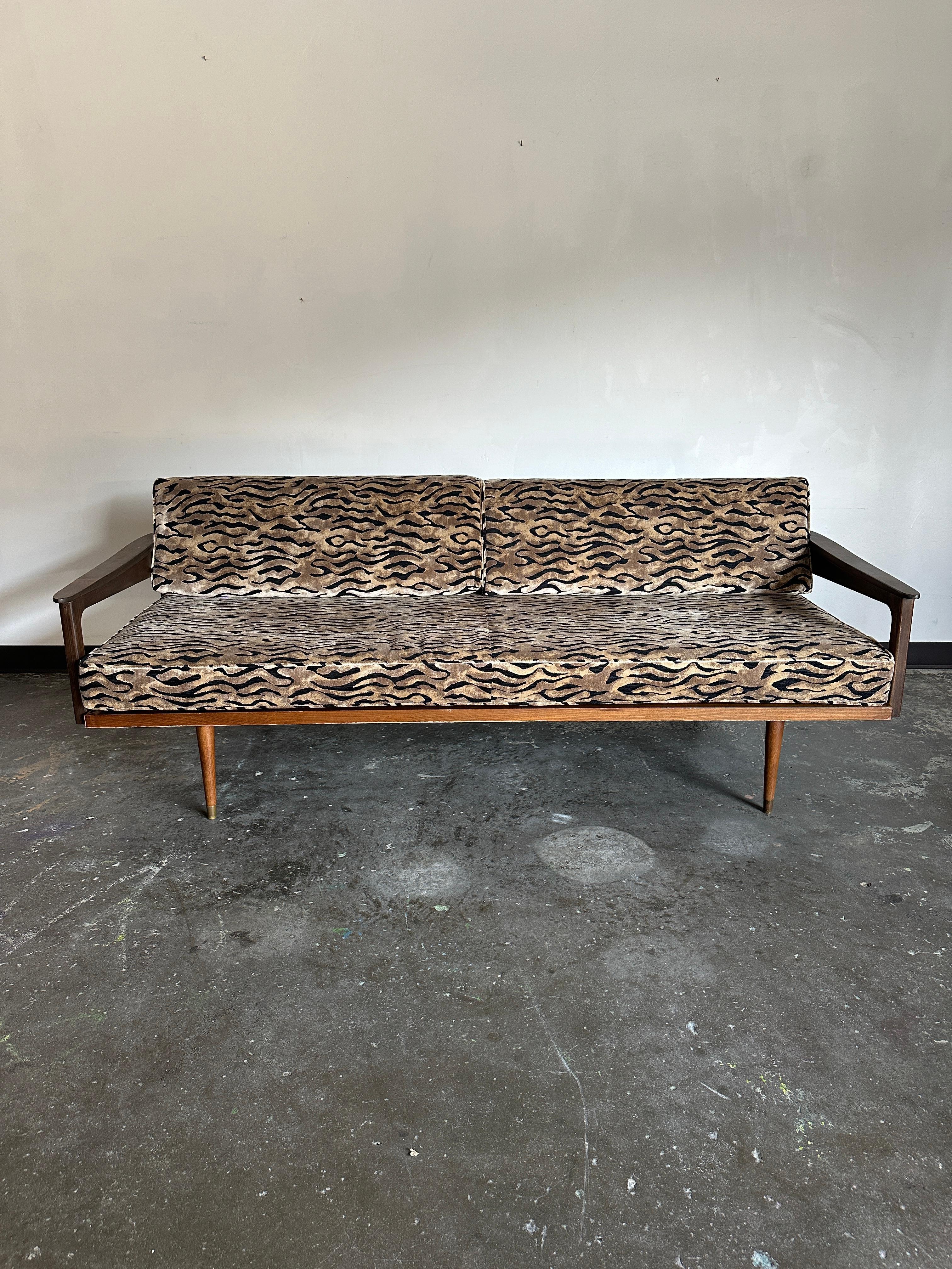 1960s sofa with refinished wooden frame and newly upholstered cushions. In excellent vintage condition. Cushions consist of three cushions: two identical back cushions, and one large cushion for the seat. Each cushion features a zippered cover. The