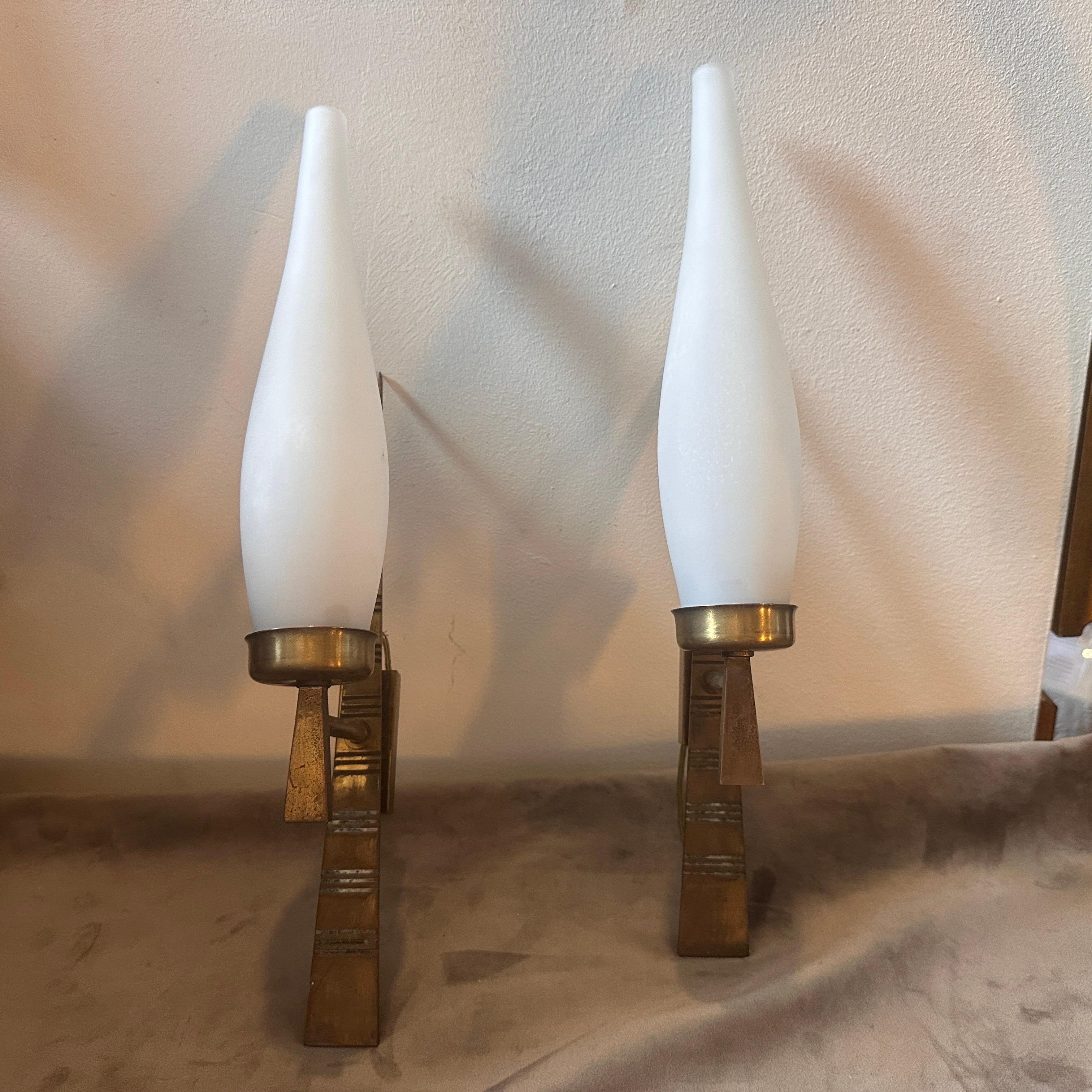 This pair of Wall Sconces designed and manufactured in Italy in the Sixties are iconic examples of lighting fixtures that emerged during the mid-20th century. These sconces combine elements of both form and function, reflecting the design aesthetics