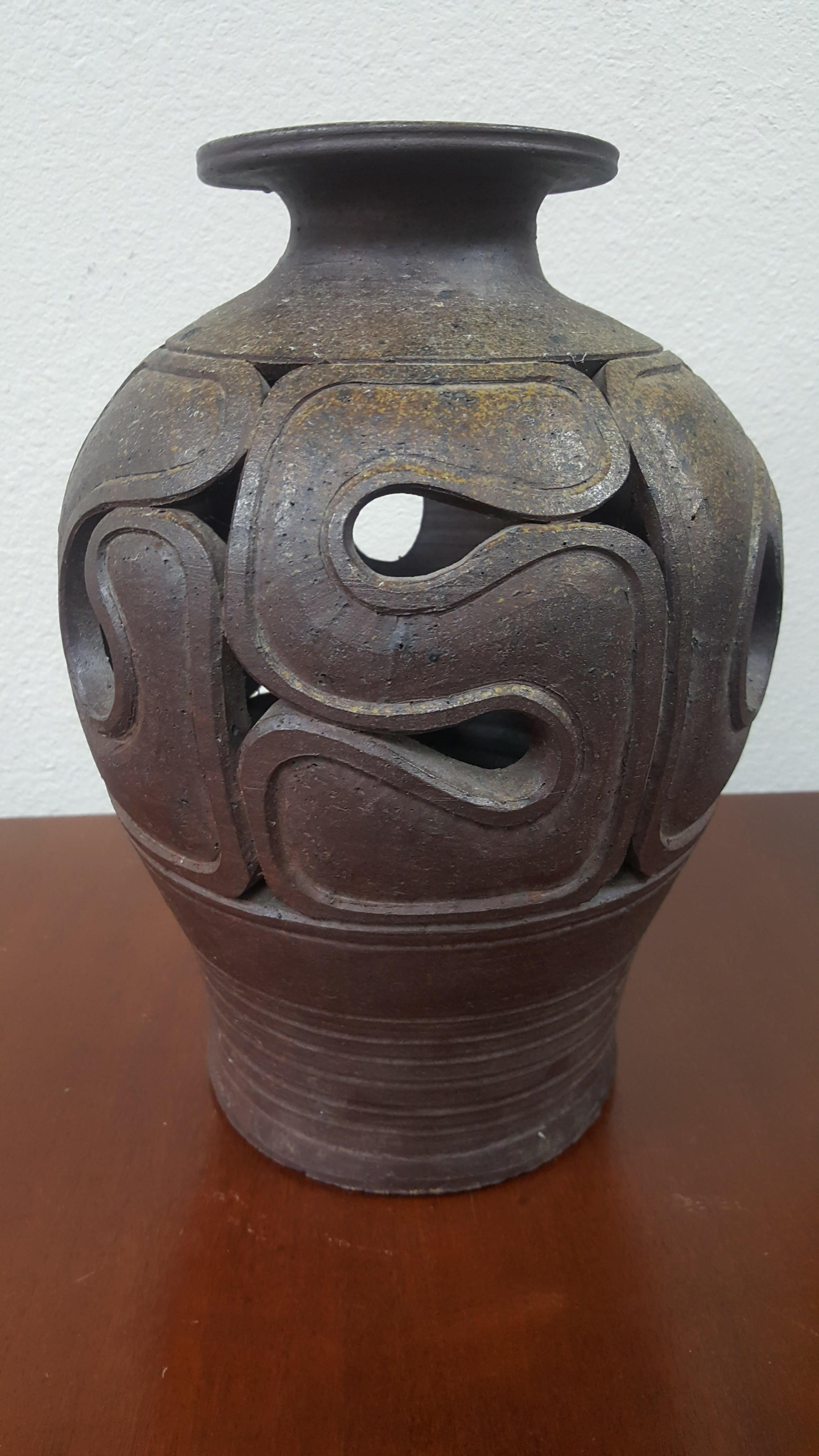 Stoneware vase vintage 1960s stoneware vase.

Excellent craftsmanship, excellent excellent condition, excellent example of Mid-Century Modern artistry captured in stoneware.
The handcrafted stoneware vase has a beautiful sculpted design.
I see no