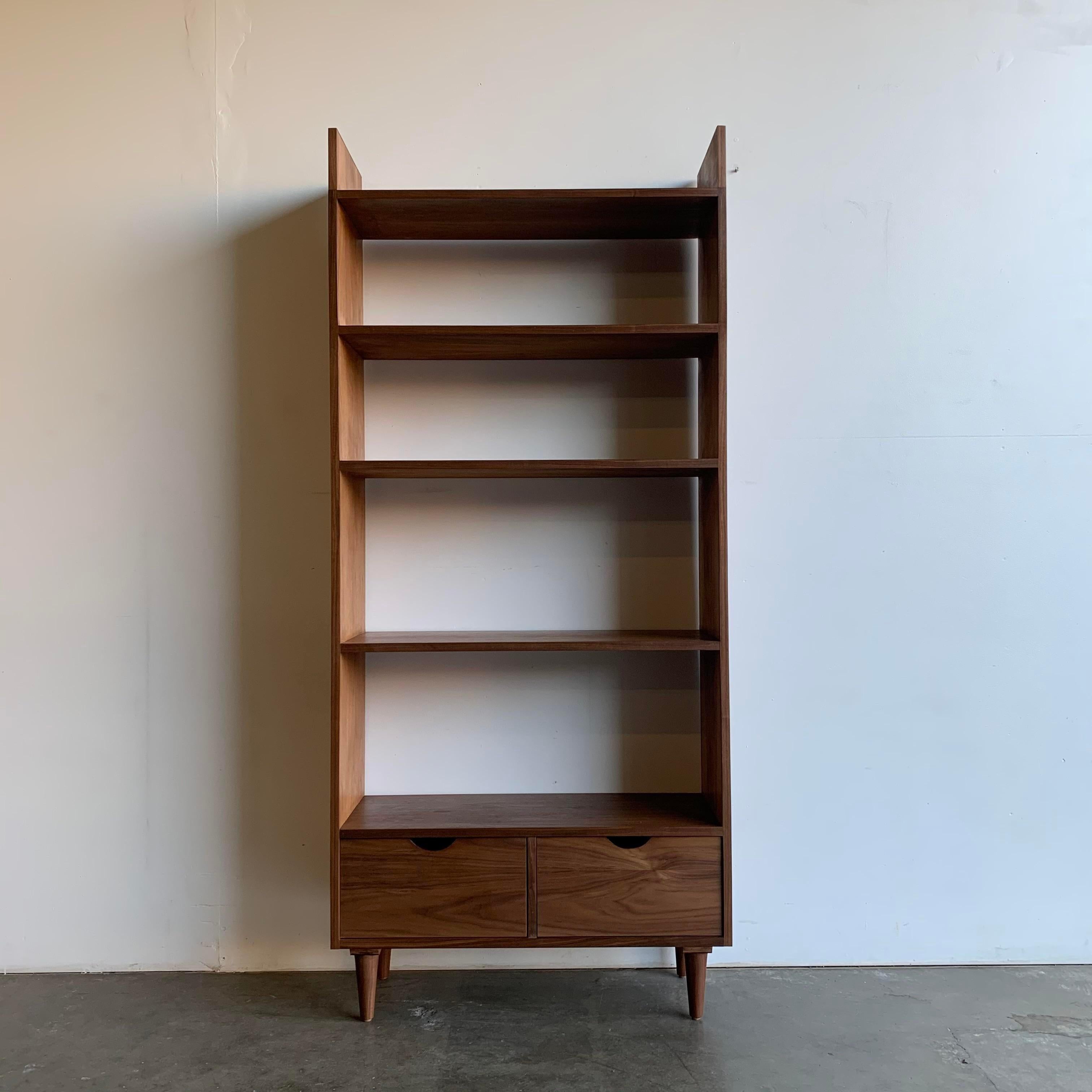 Handcrafted in house for a staging project. Item offers a clean minimal design, extended top for added storage and two drawers for closed storage. Made in solid and walnut veneer.