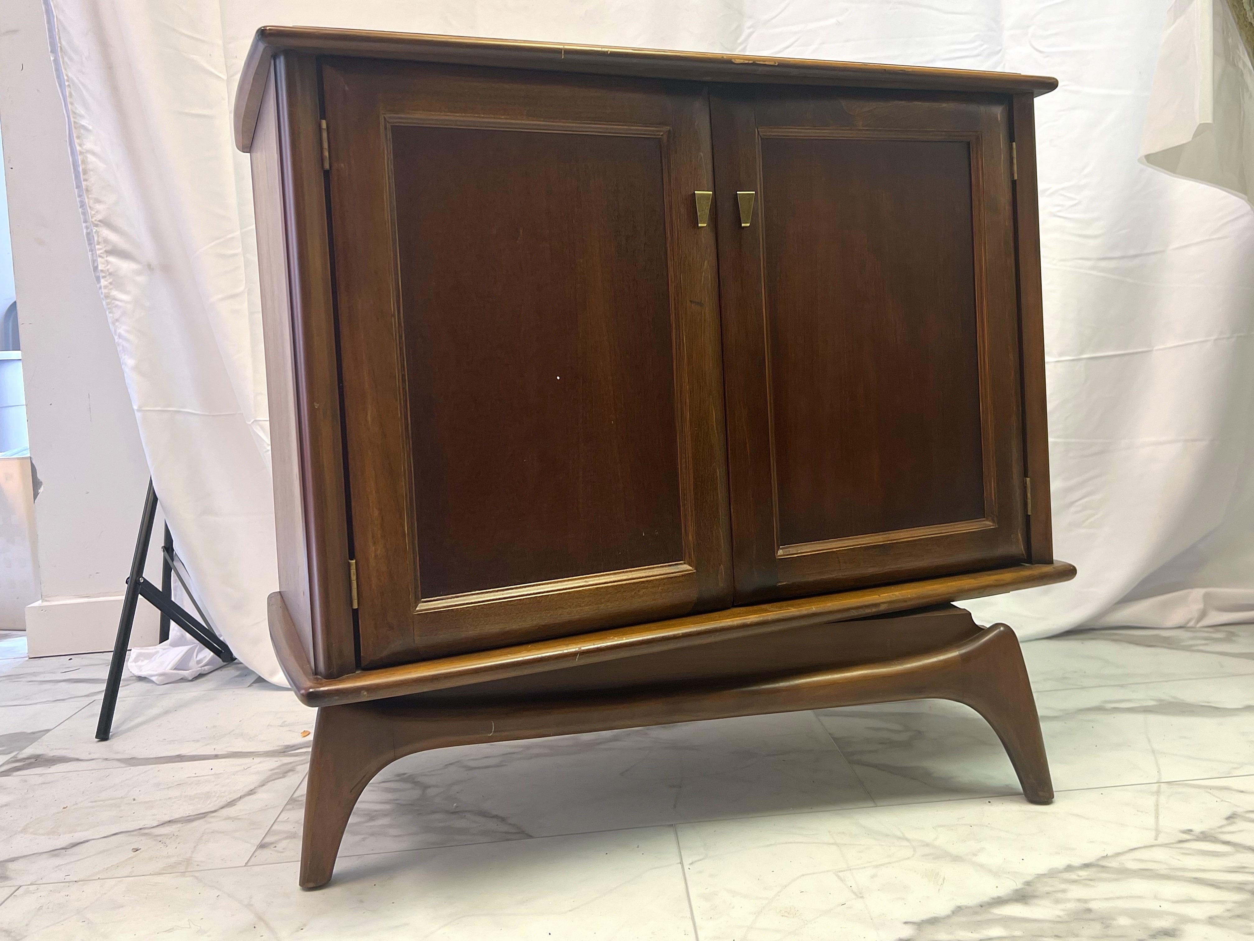For your consideration I have a solid wood swivel tv cabinet that has been gutted and was used as a more modern tv cabinet equipped with new shelves. The sculpted splayed legs in which this piece swivels on are a perfect addition to your midmod