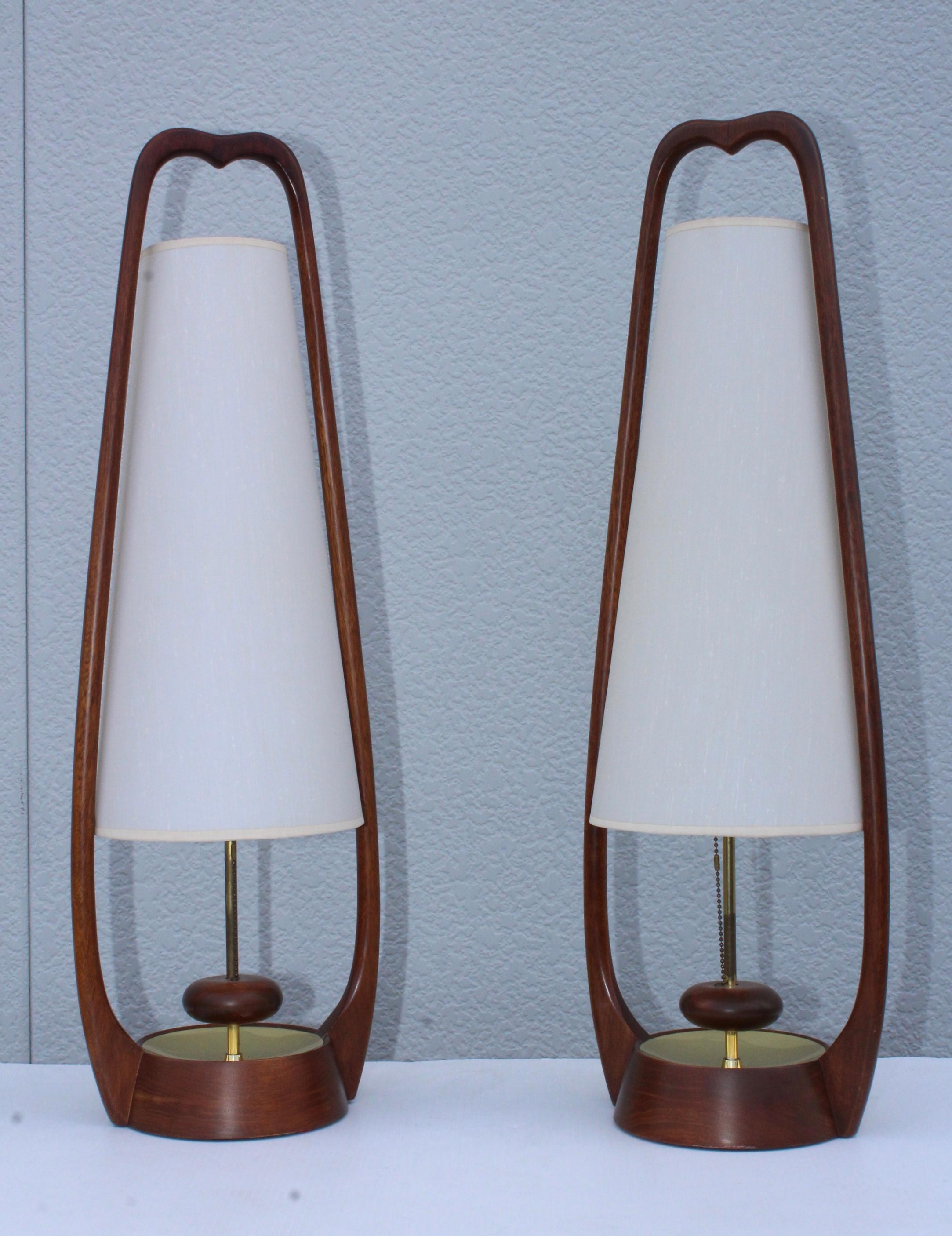 Stunning pair of 1960s midcentury walnut table lamps. In vintage condition, newly professionally rewired and ready to use.
