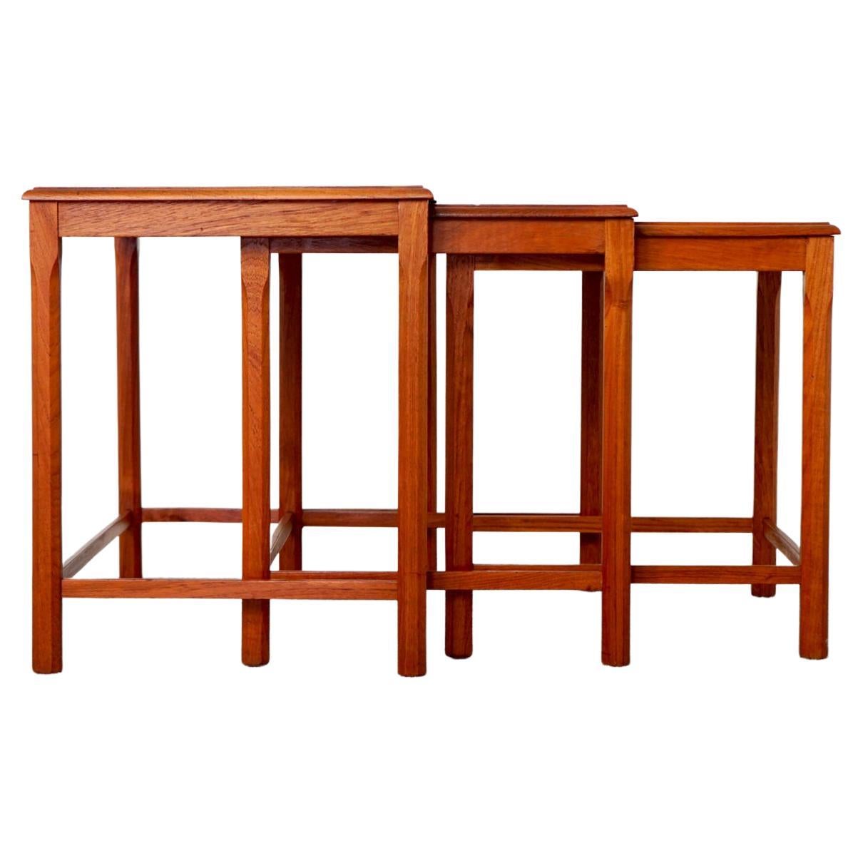 Teak and tile mid-century nesting tables, circa 1960's. Use them individually or nest them together to save space! Each tables features quintessential Scandinavian tile motifs, perfect for placing your drinks, built-in coasters! Space saving design