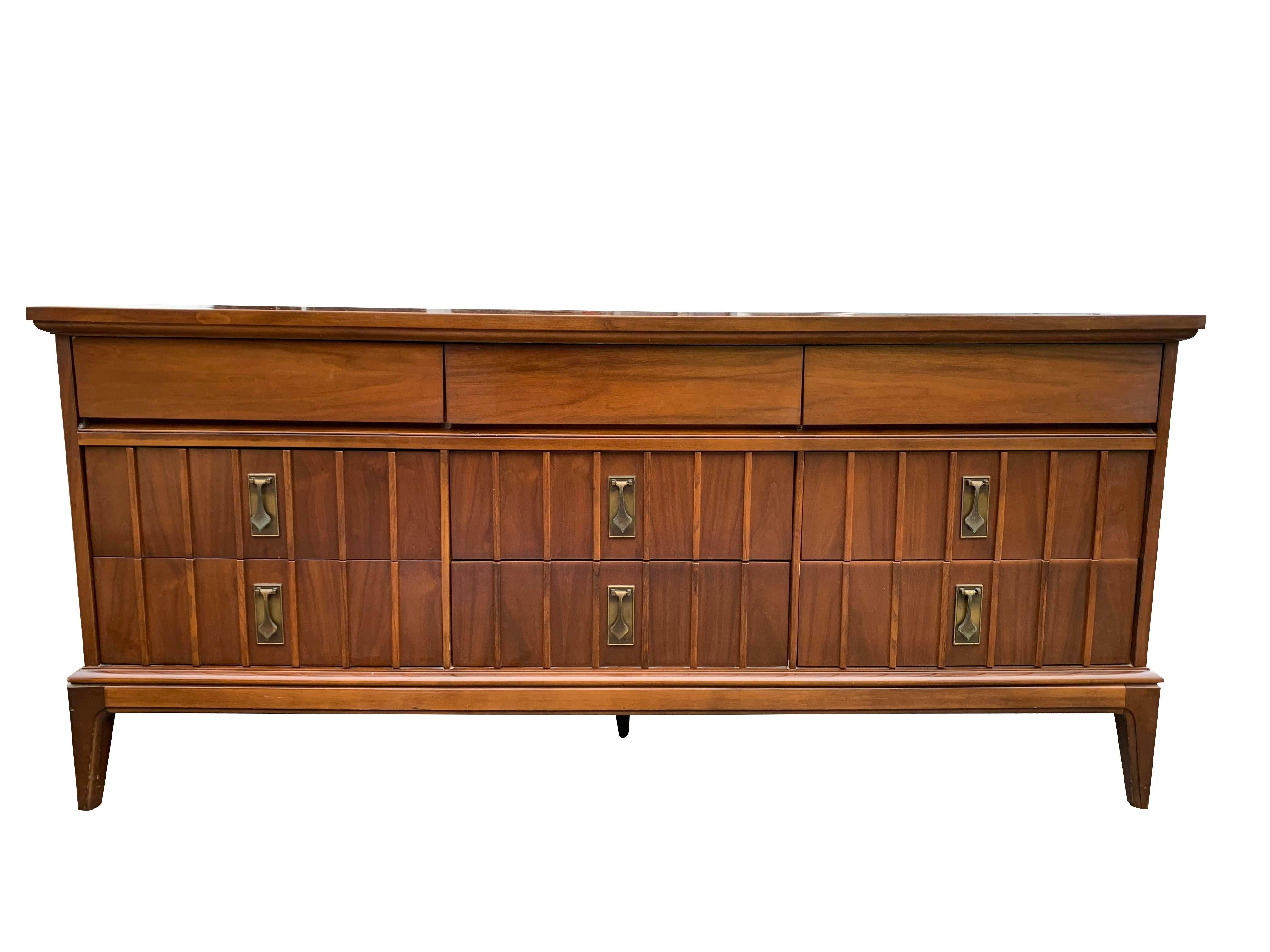 Vintage 1960s Mid-Century Modern Triple Dresser with Brass Hardware

This vintage dresser is a must-have for anyone looking to add a touch of retro style and functionality to their home. The unique design and high-quality materials make it a