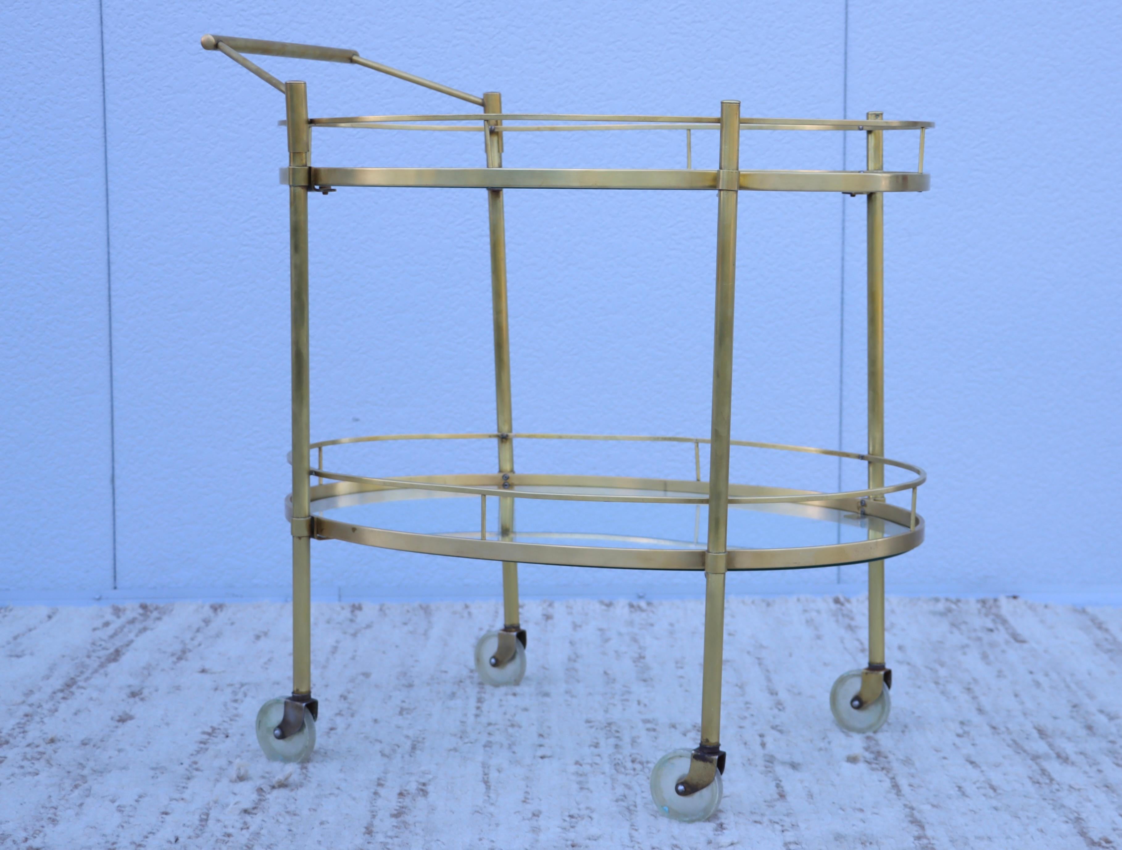 1960's Mid-Century Modern two tier solid brass and glass bar cart, in vintage condition with some wear and patina due to age and use, lightly hand polished.