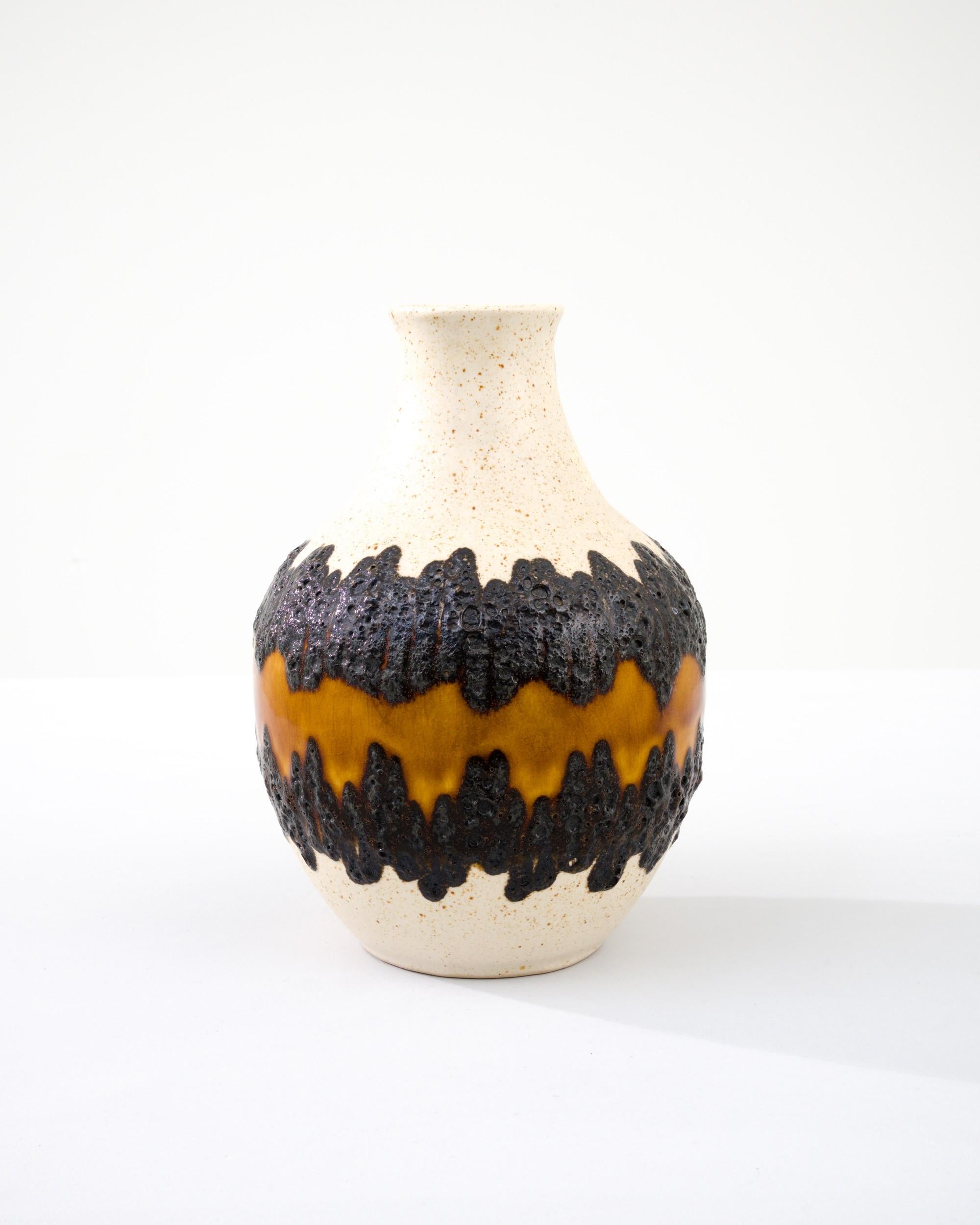 A ceramic vase from mid-20th century Germany. Neither large nor small, this studio made pot reflects the hand-held, and the handmade; the tactility of process and the artist's vision– realized on the potter’s wheel. Thick textured stripes ring the