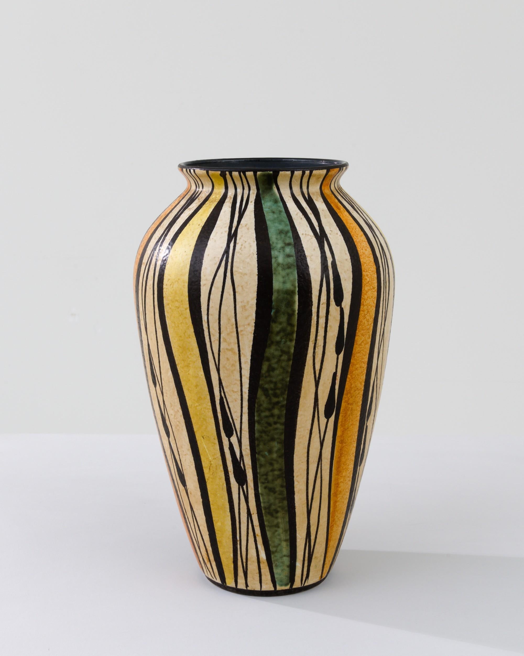A ceramic vase from mid-20th century Germany. Neither large nor small, this studio made pot reflects the hand-held, and the handmade; the tactility of process and the artist's vision– realized on the potter’s wheel. Graphic lines cut through