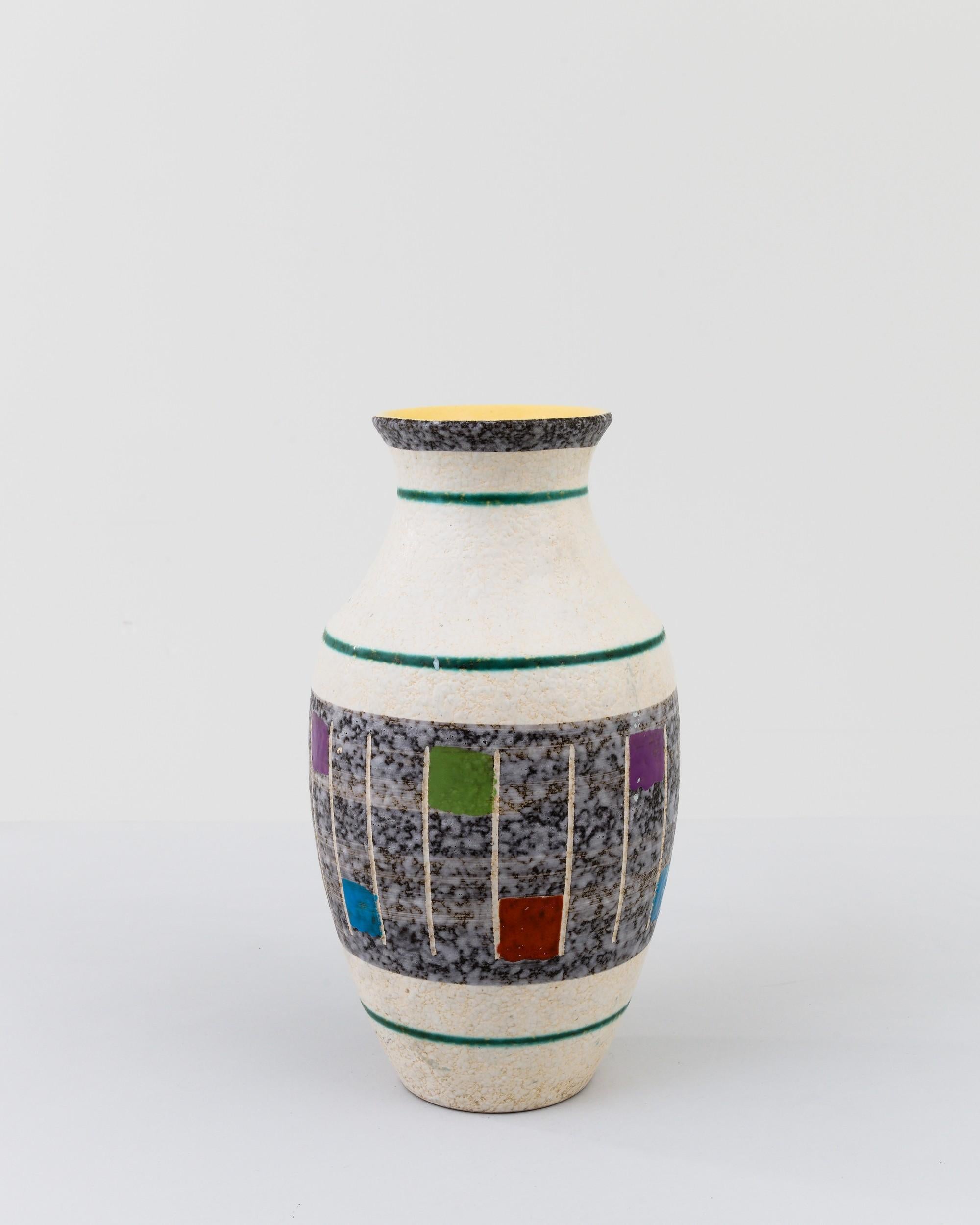 A ceramic vase from mid-20th century Germany. Neither large nor small, this studio made pot reflects the hand-held, and the handmade; the tactility of process and the artist's vision– realized on the potter’s wheel. Thickly glazed with graphic pops