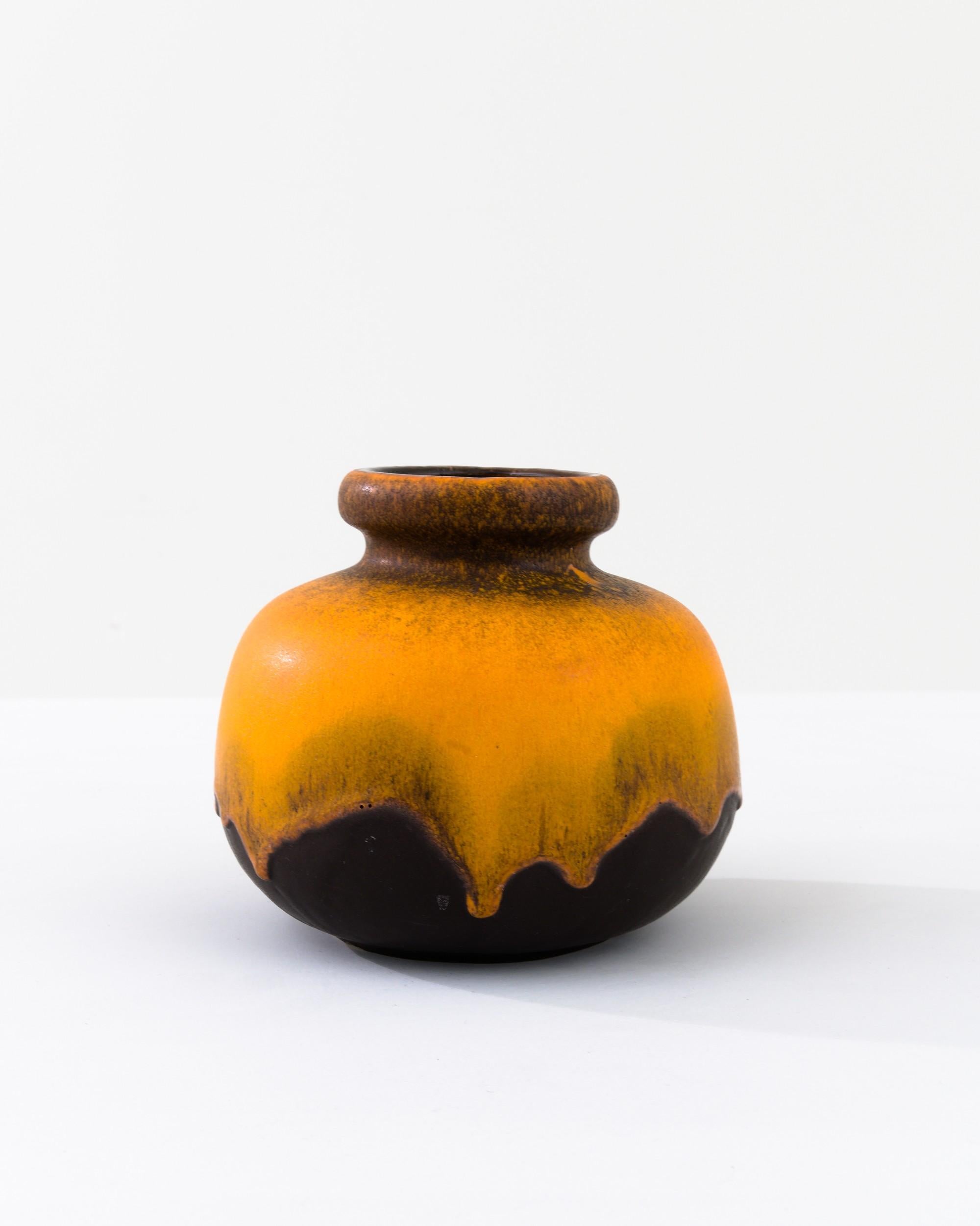 A ceramic vase from mid-20th century Germany. Neither large nor small, this studio made pot reflects the hand-held, and the handmade; the tactility of process and the artist's vision– realized on the potter’s wheel. Dripping with a thick glaze, the