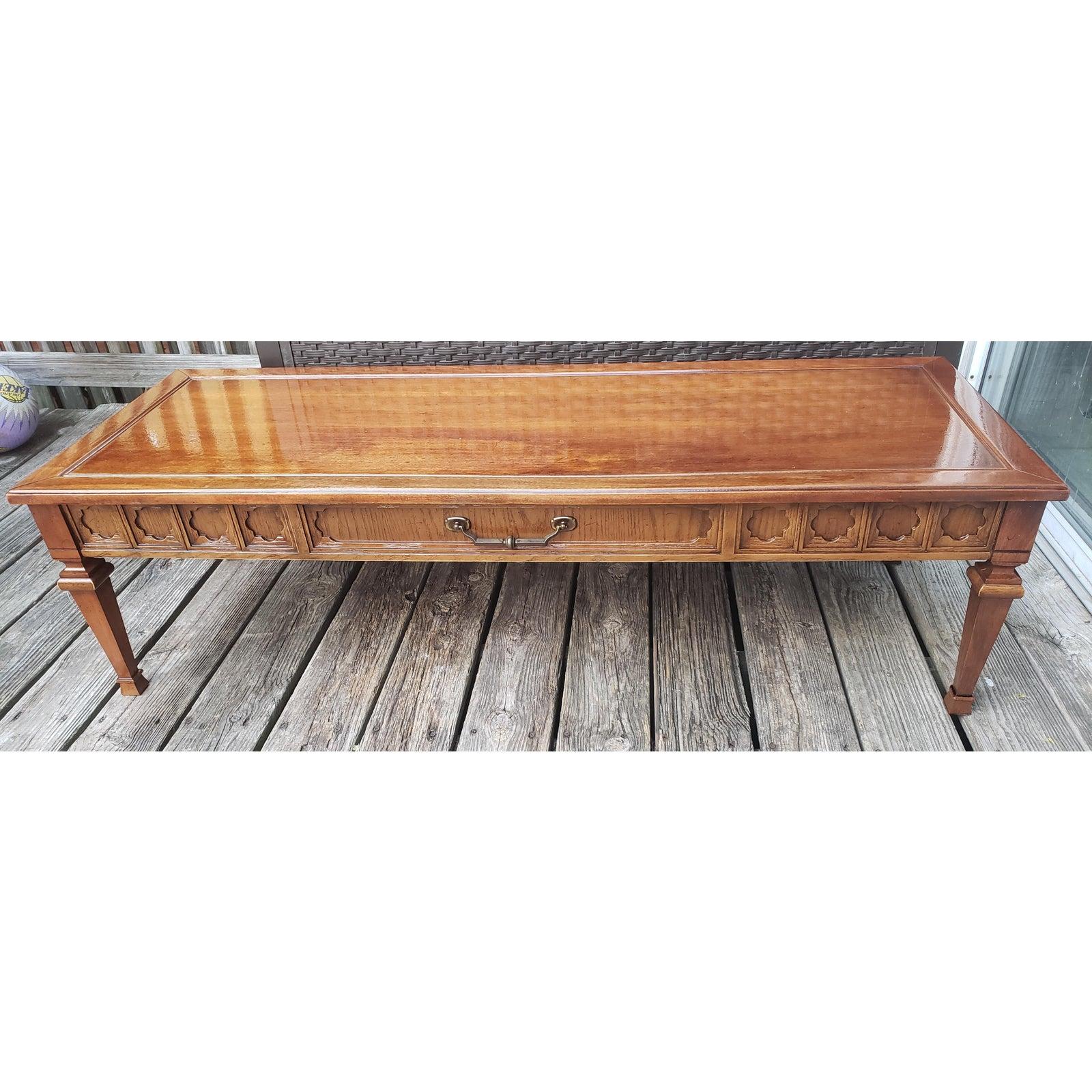 For your consideration is this fabulous 1967 Walnut Coffee Table featuring carved front with brass handle and faux drawer. Table apparently has been recently refinished. Good vintage condition. Table measures 54W x 20D x 15H.
 