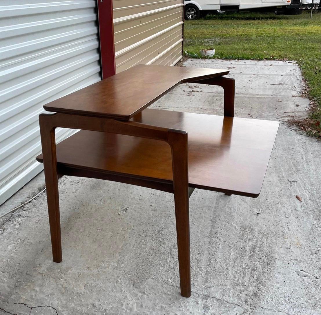 Vintage Mid-Century Modern corner table. This table would be perfect as a divider for a sectional. It’s not solid walnut but it is all wood. No particle board! It’s got great shapely legs. Minimalist in design. Unfortunately, there is no maker's