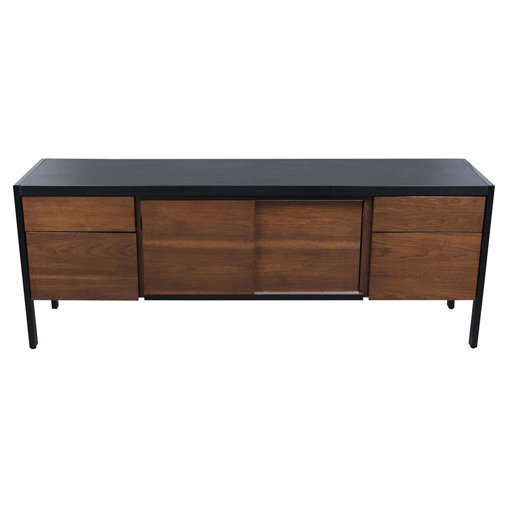 A 1960s modern credenza handcrafted out of walnut wood features a dark walnut and ebonized color combination finished in a beautiful new lacquered finish. This cabinet comes with two pullout drawers and two-slice doors with plenty of interior
